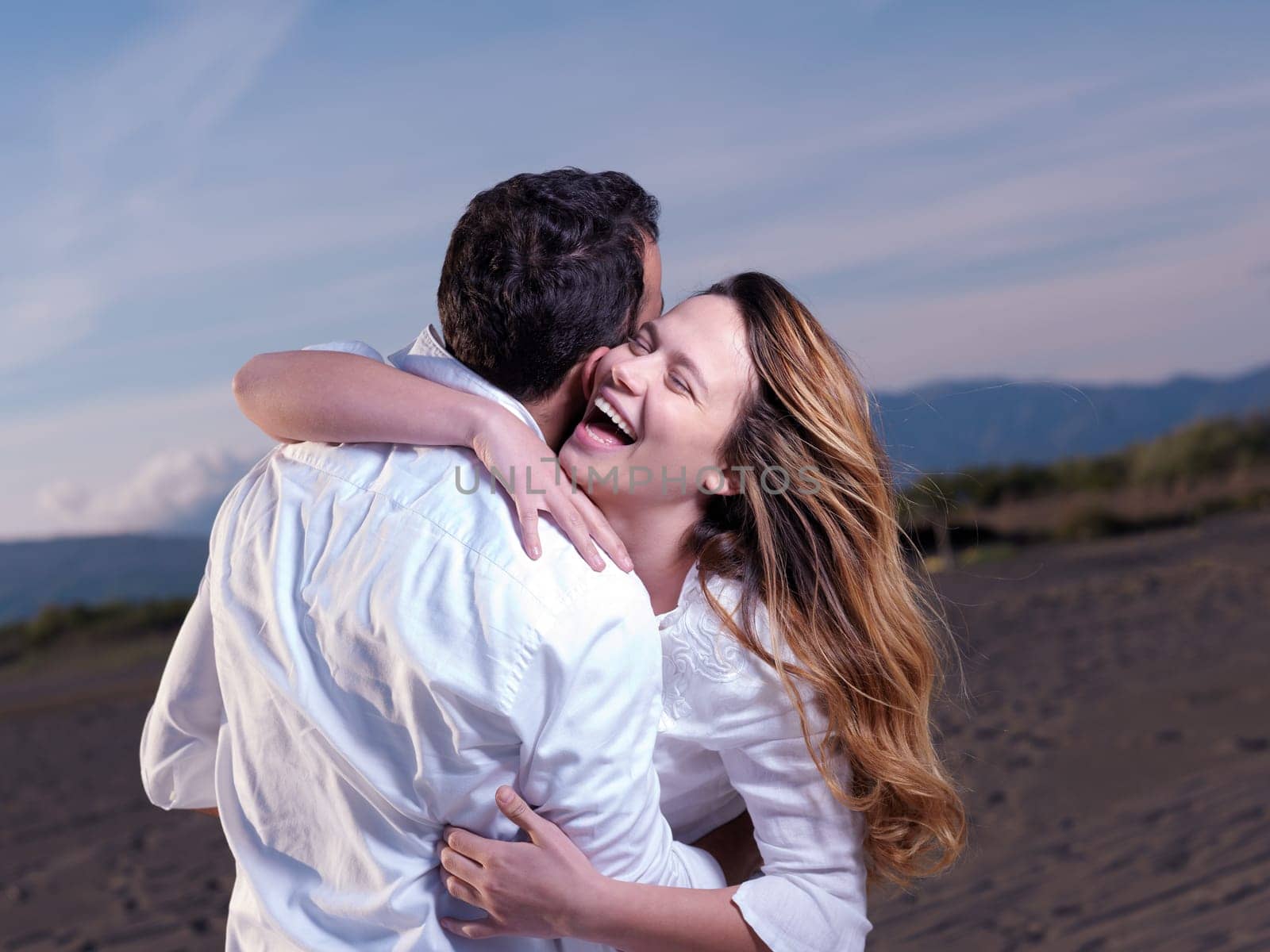 happy young romantic couple in love have fun on beautiful beach at beautiful summer day
