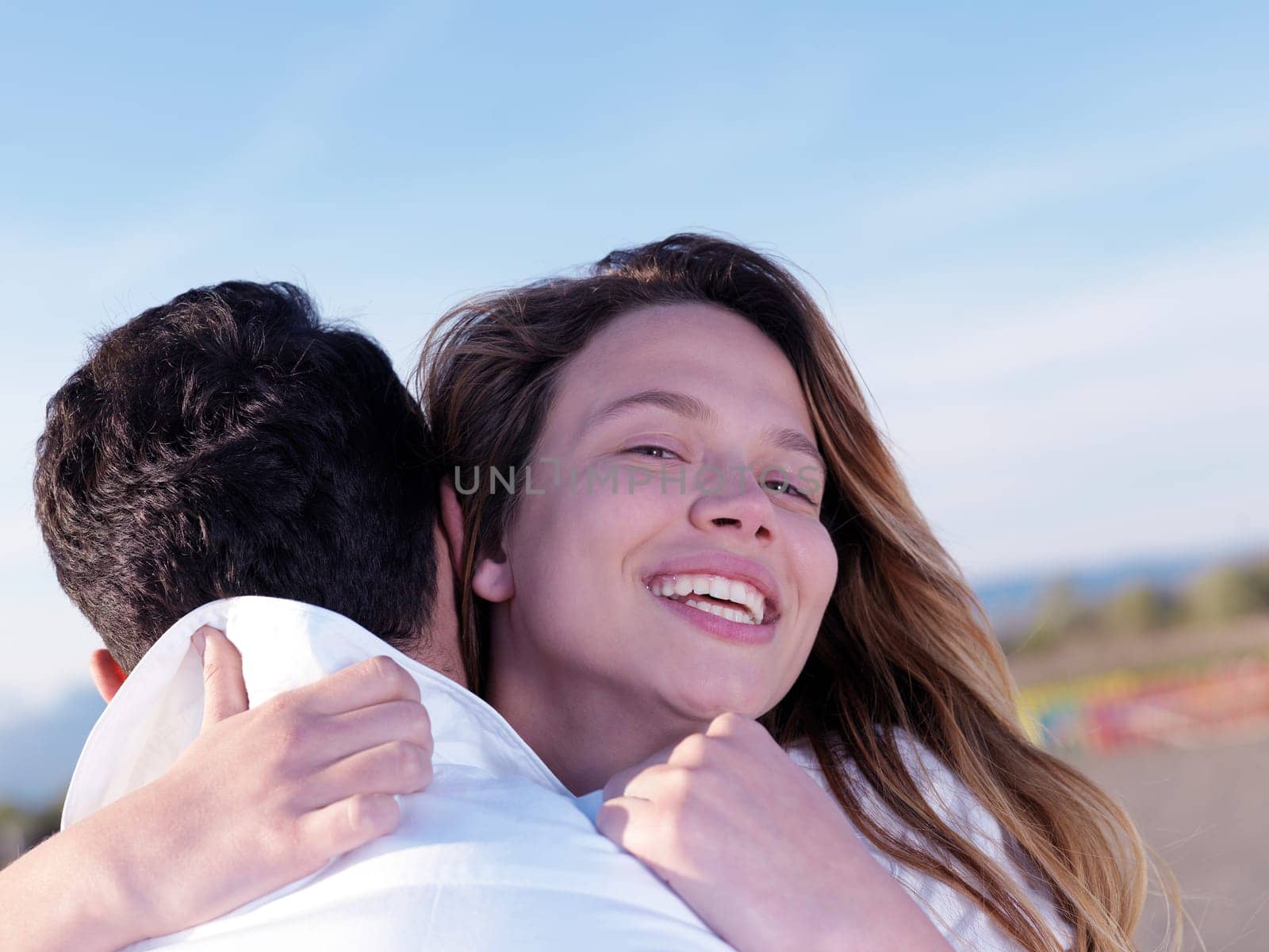 happy young romantic couple in love have fun on beautiful beach at beautiful summer day