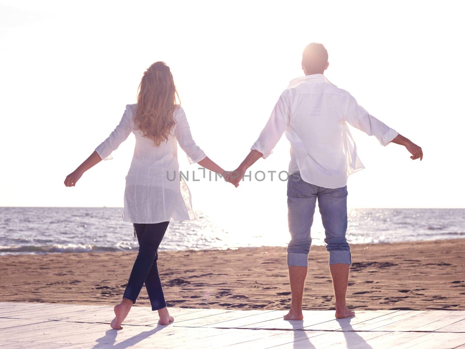 happy young romantic couple in love have fun on beautiful beach at beautiful summer day