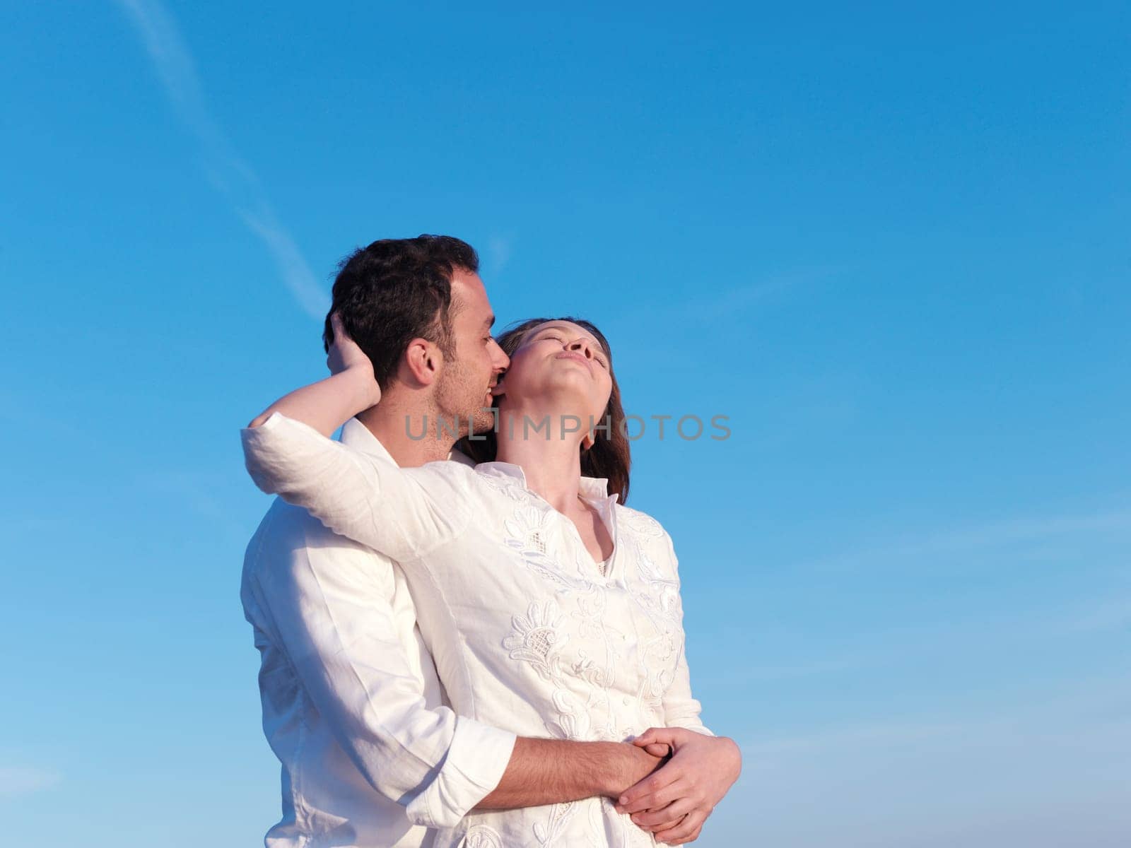 happy young romantic couple in love have fun on beautiful beach at beautiful summer day