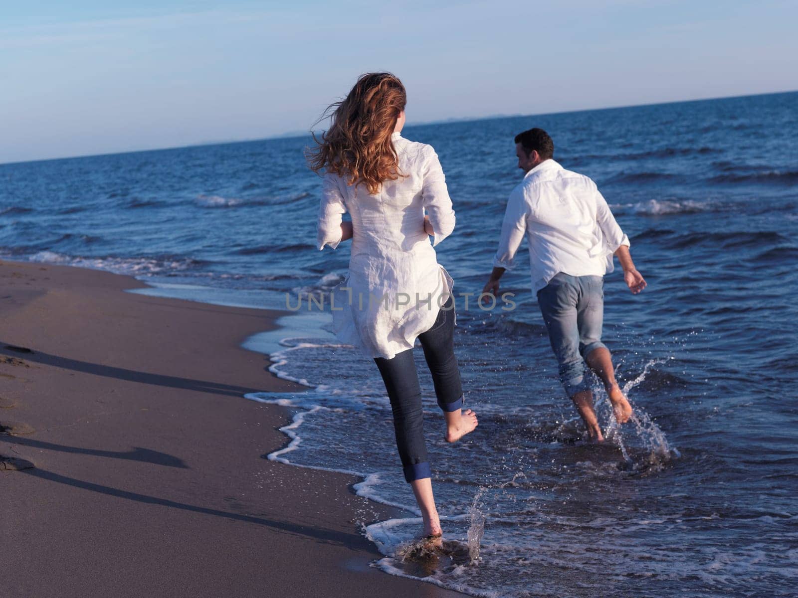 happy young romantic couple in love have fun on beautiful beach at beautiful summer day