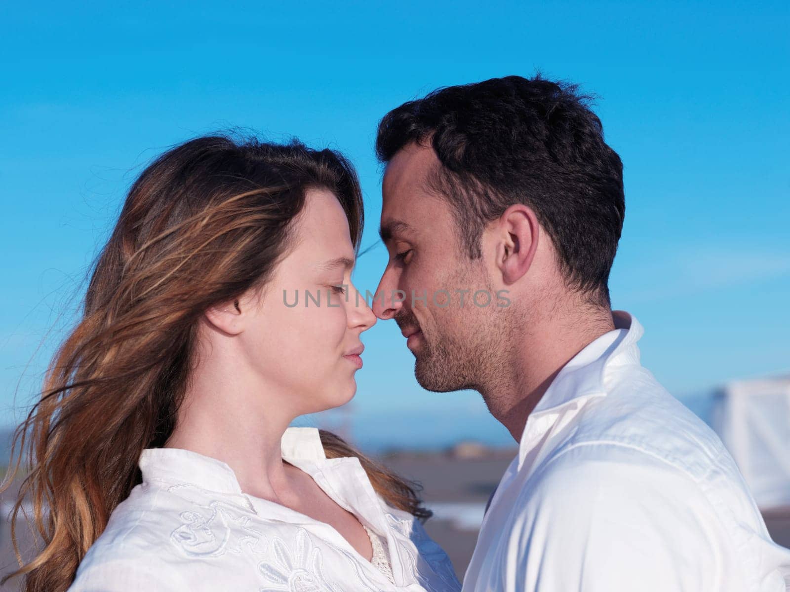 happy young romantic couple in love have fun on beautiful beach at beautiful summer day