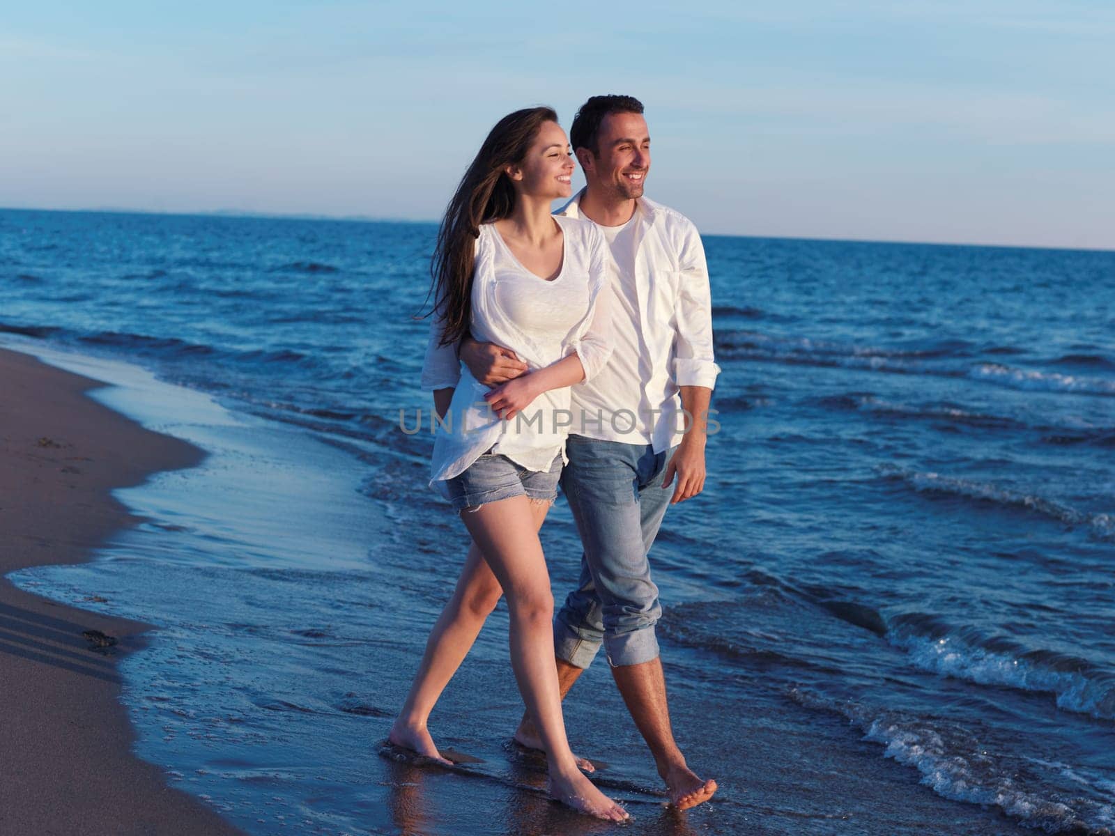 happy young romantic couple in love have fun on beautiful beach at beautiful summer day