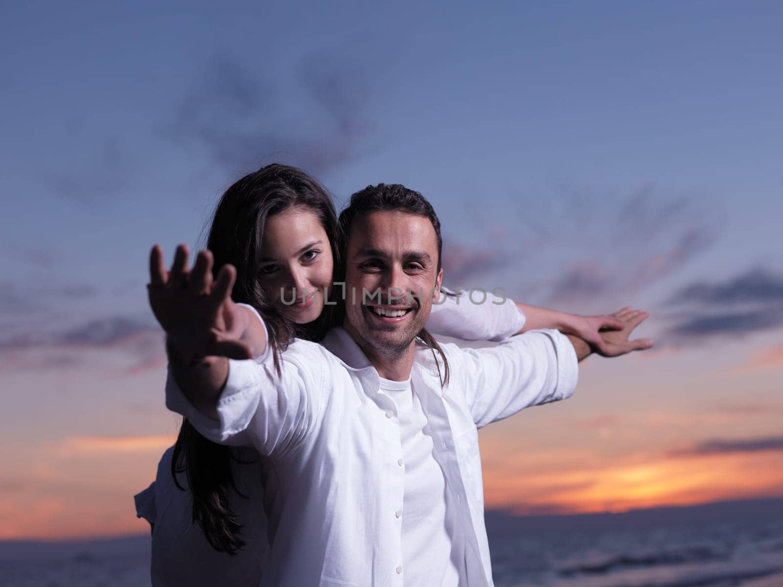 happy young romantic couple in love have fun on beautiful beach at beautiful summer day