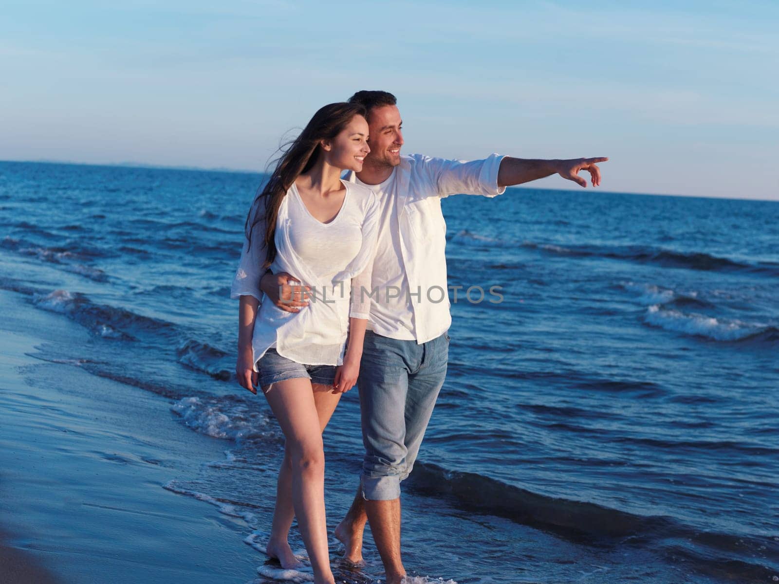 happy young romantic couple in love have fun on beautiful beach at beautiful summer day