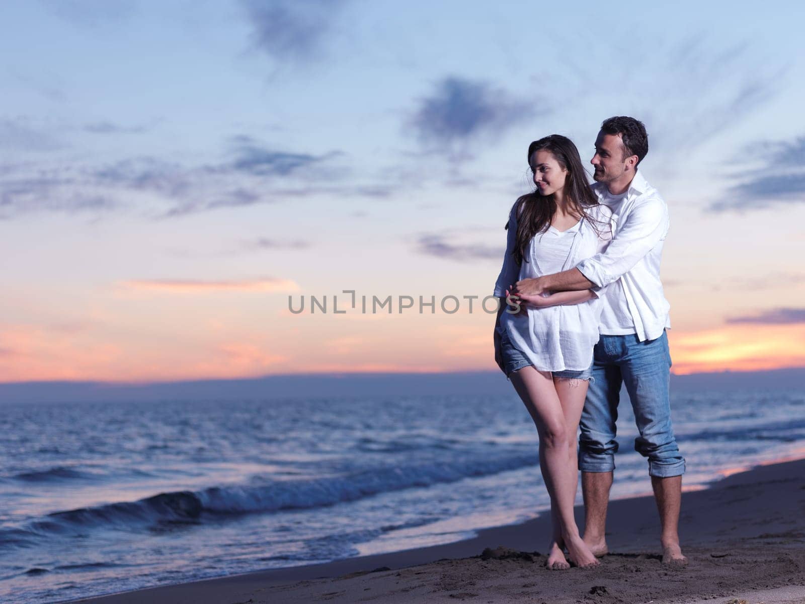 happy young romantic couple in love have fun on beautiful beach at beautiful summer day