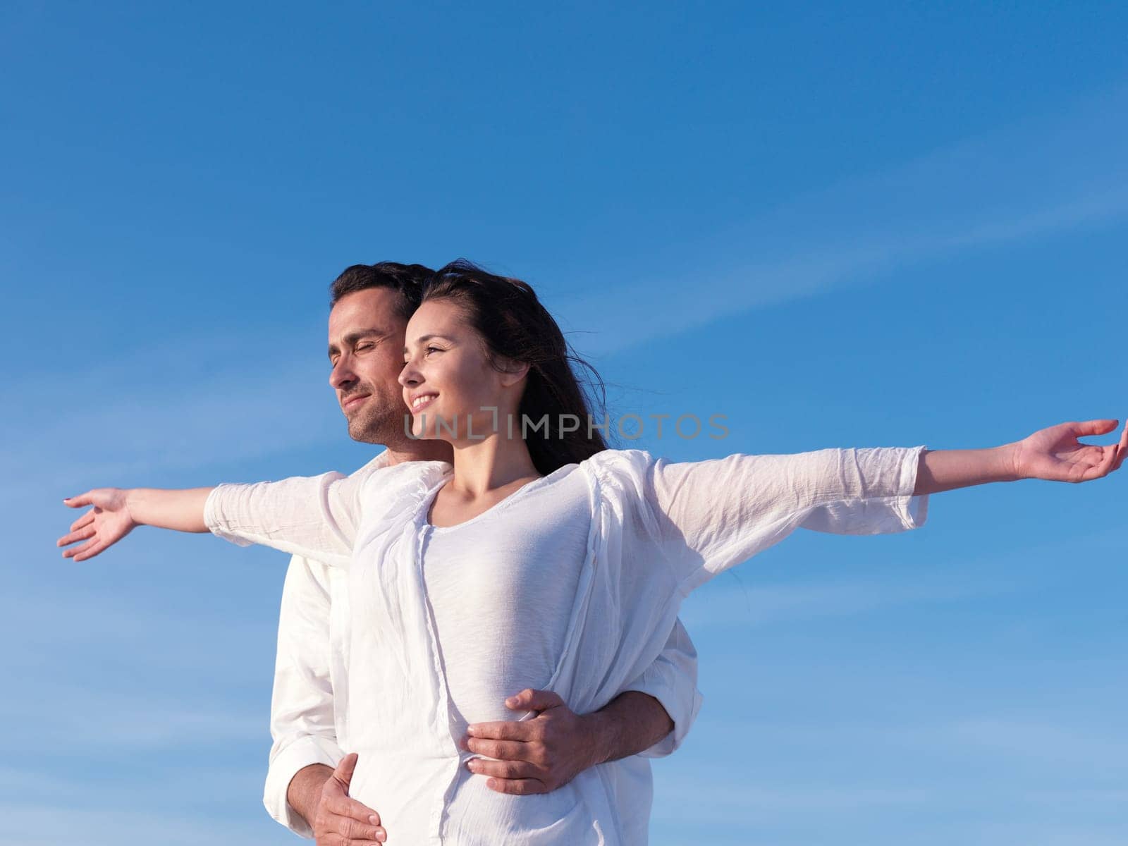 happy young romantic couple in love have fun on beautiful beach at beautiful summer day