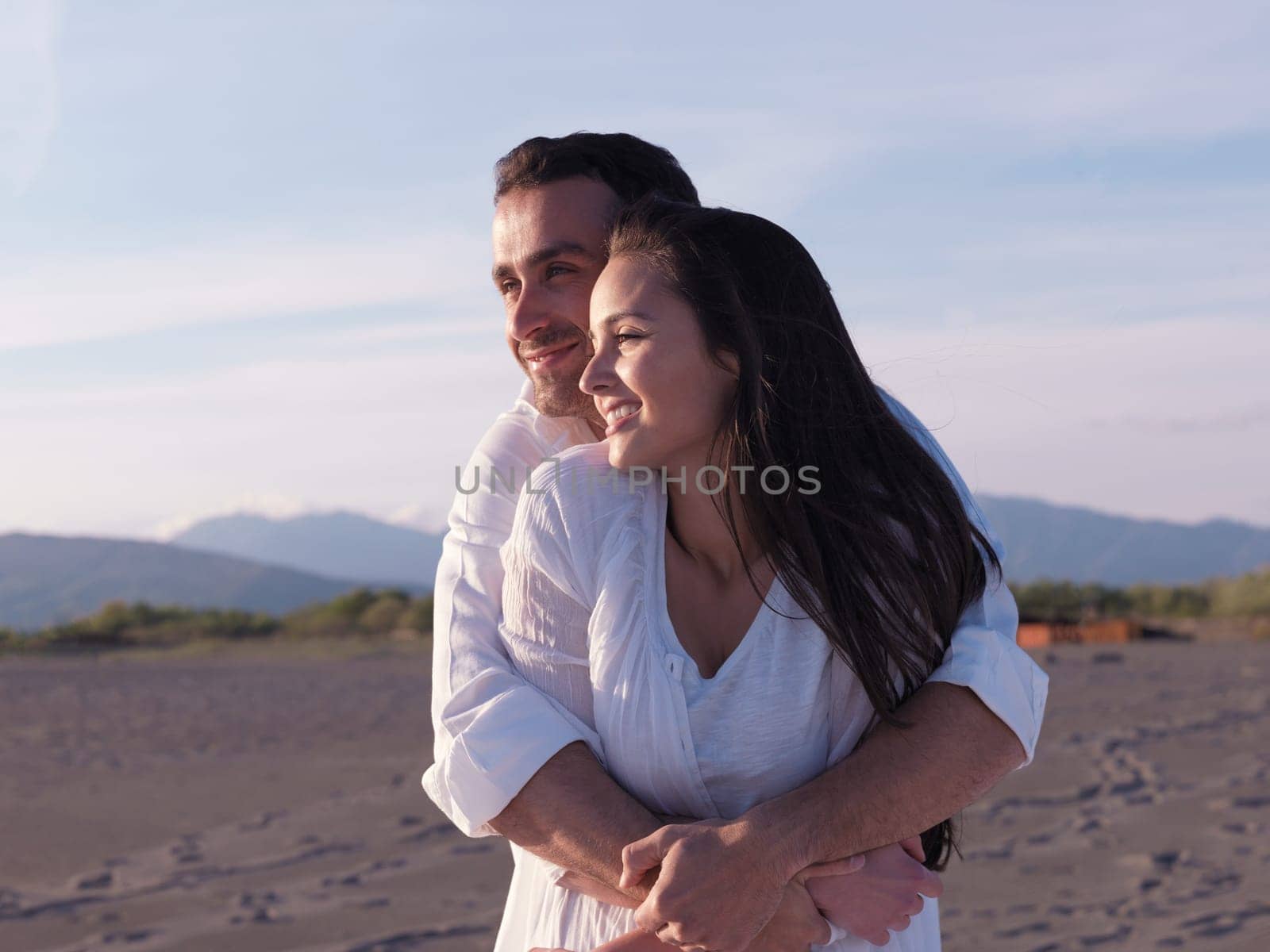 happy young romantic couple in love have fun on beautiful beach at beautiful summer day