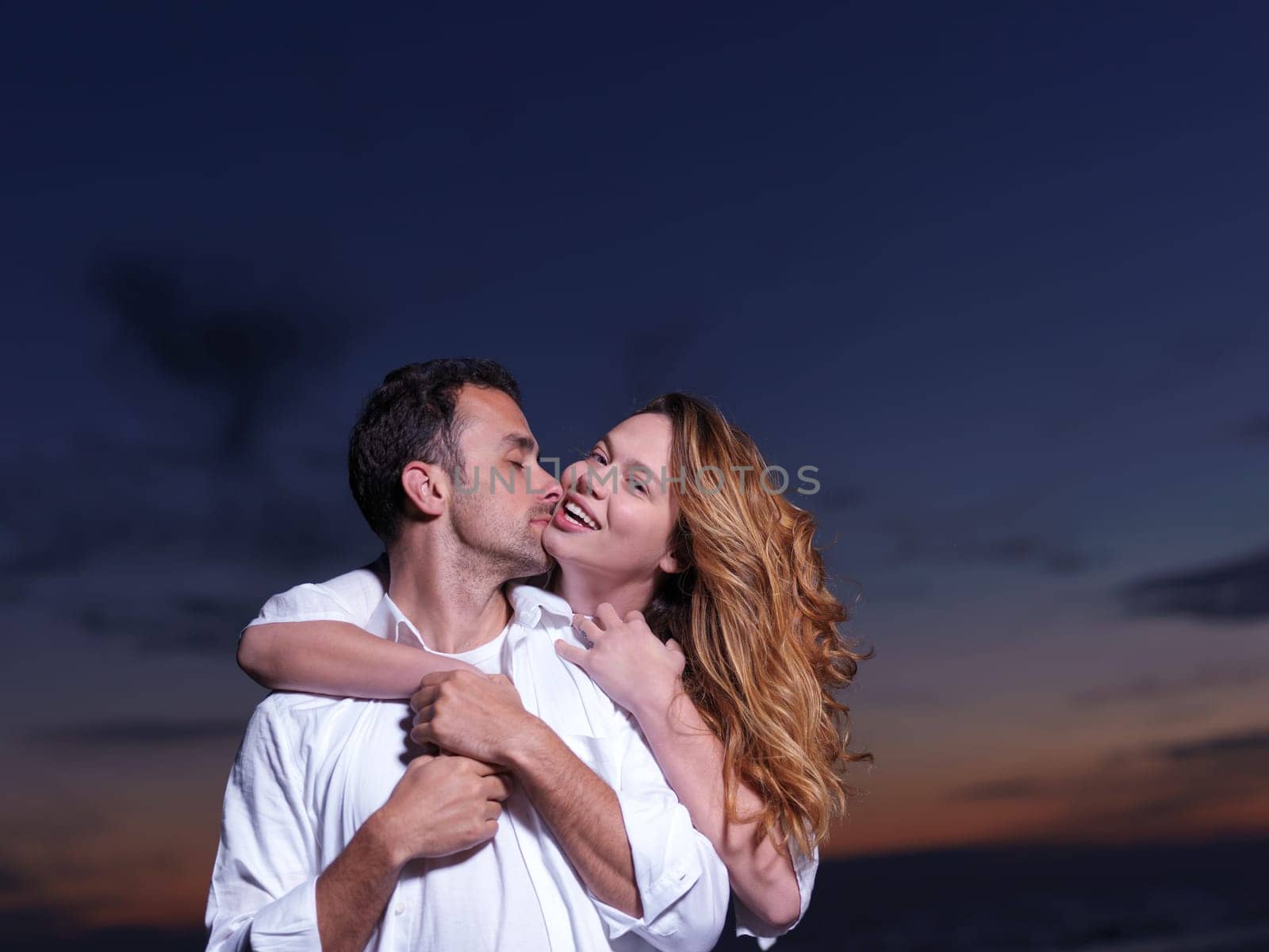 happy young romantic couple in love have fun on beautiful beach at beautiful summer day