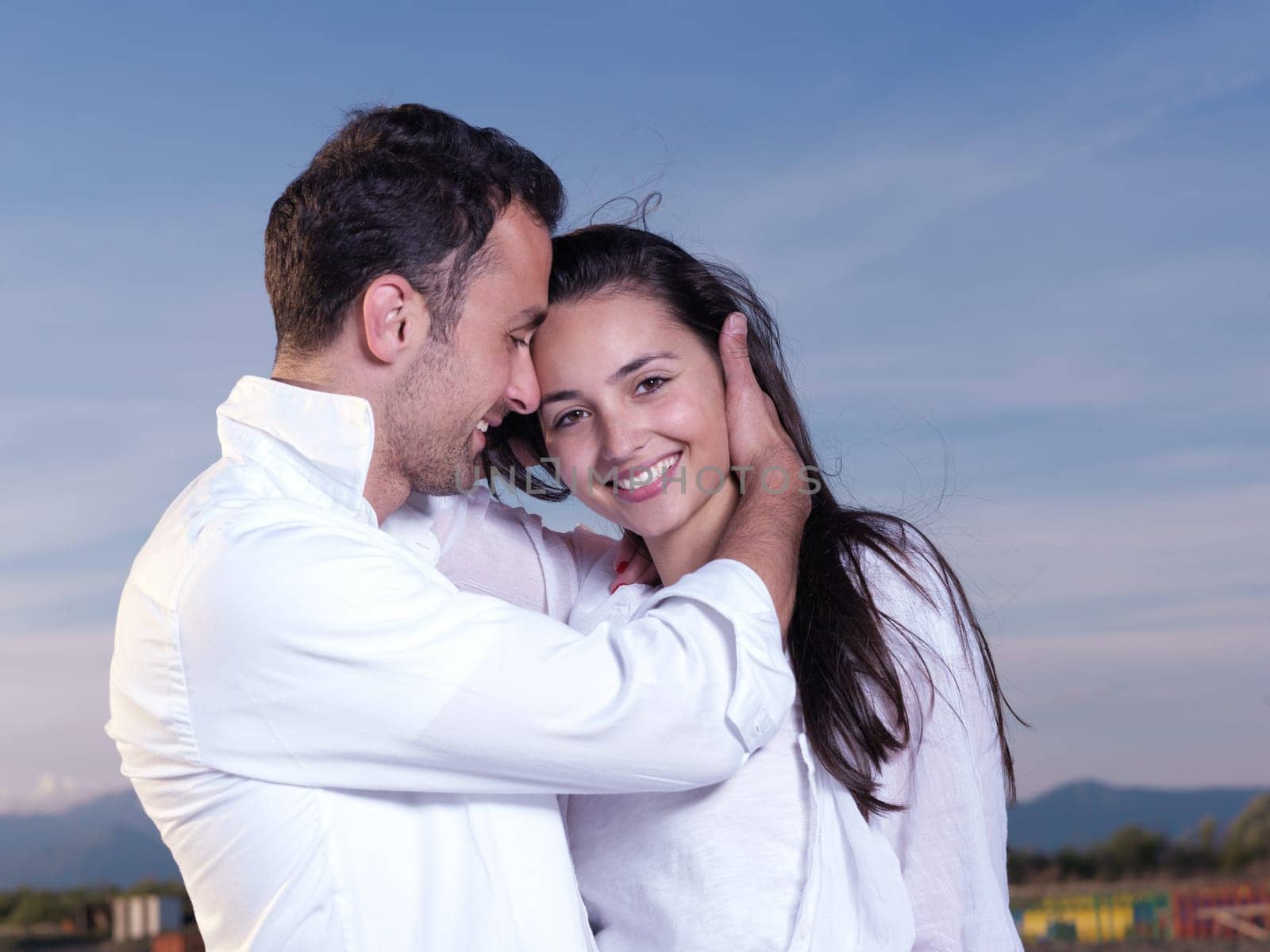 happy young romantic couple in love have fun on beautiful beach at beautiful summer day