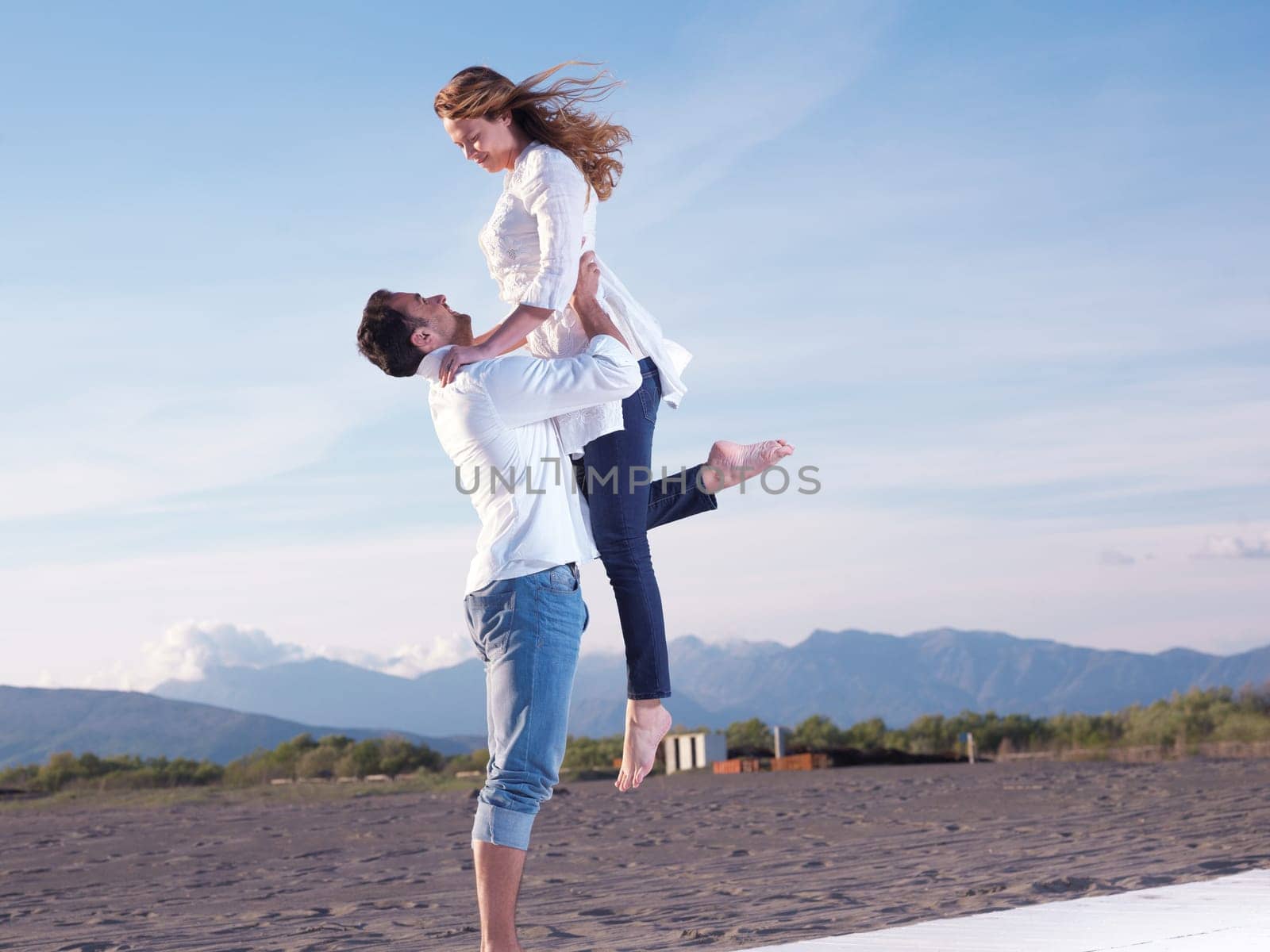happy young romantic couple in love have fun on beautiful beach at beautiful summer day
