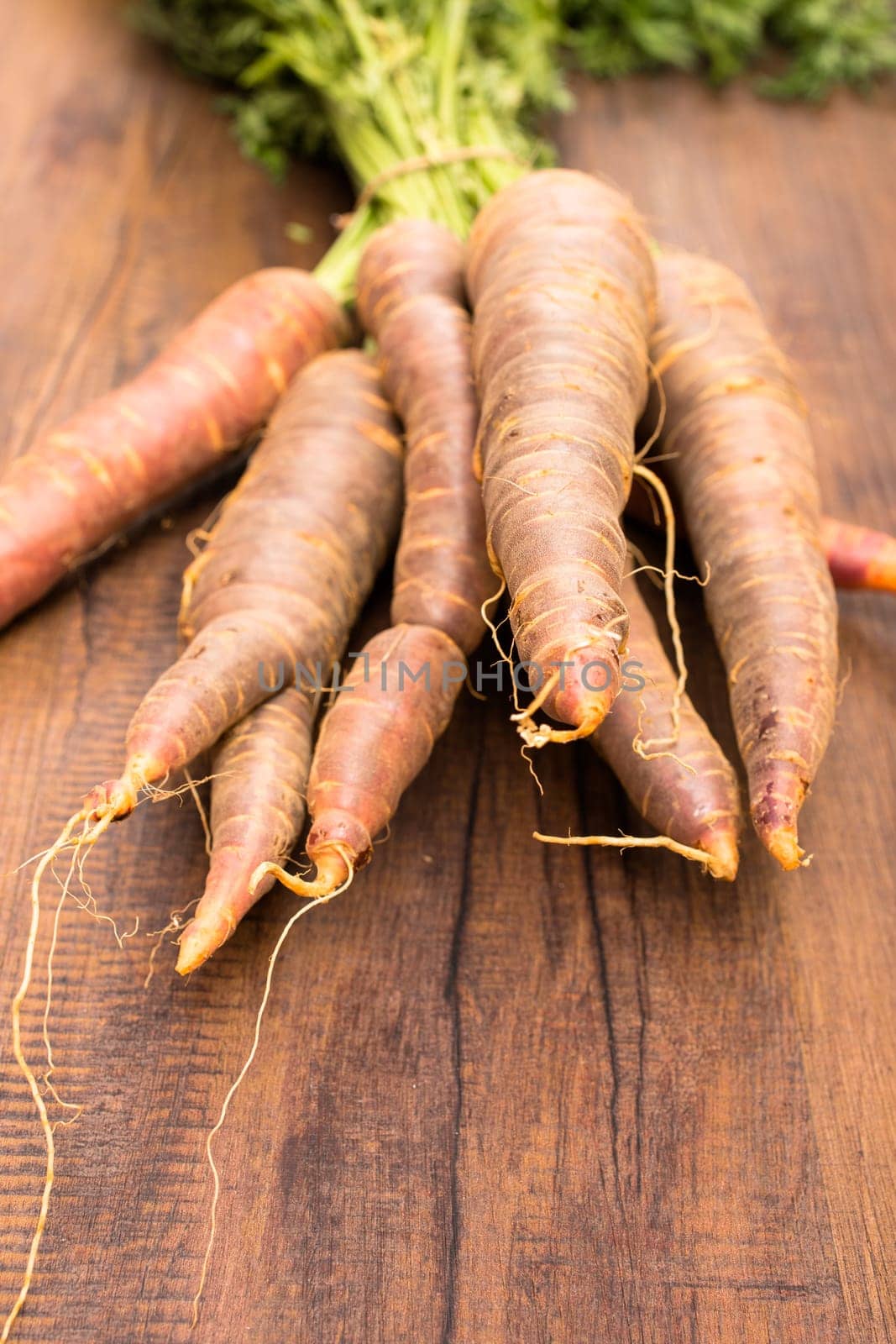 Vegetables Urcarrots with green in portrait format