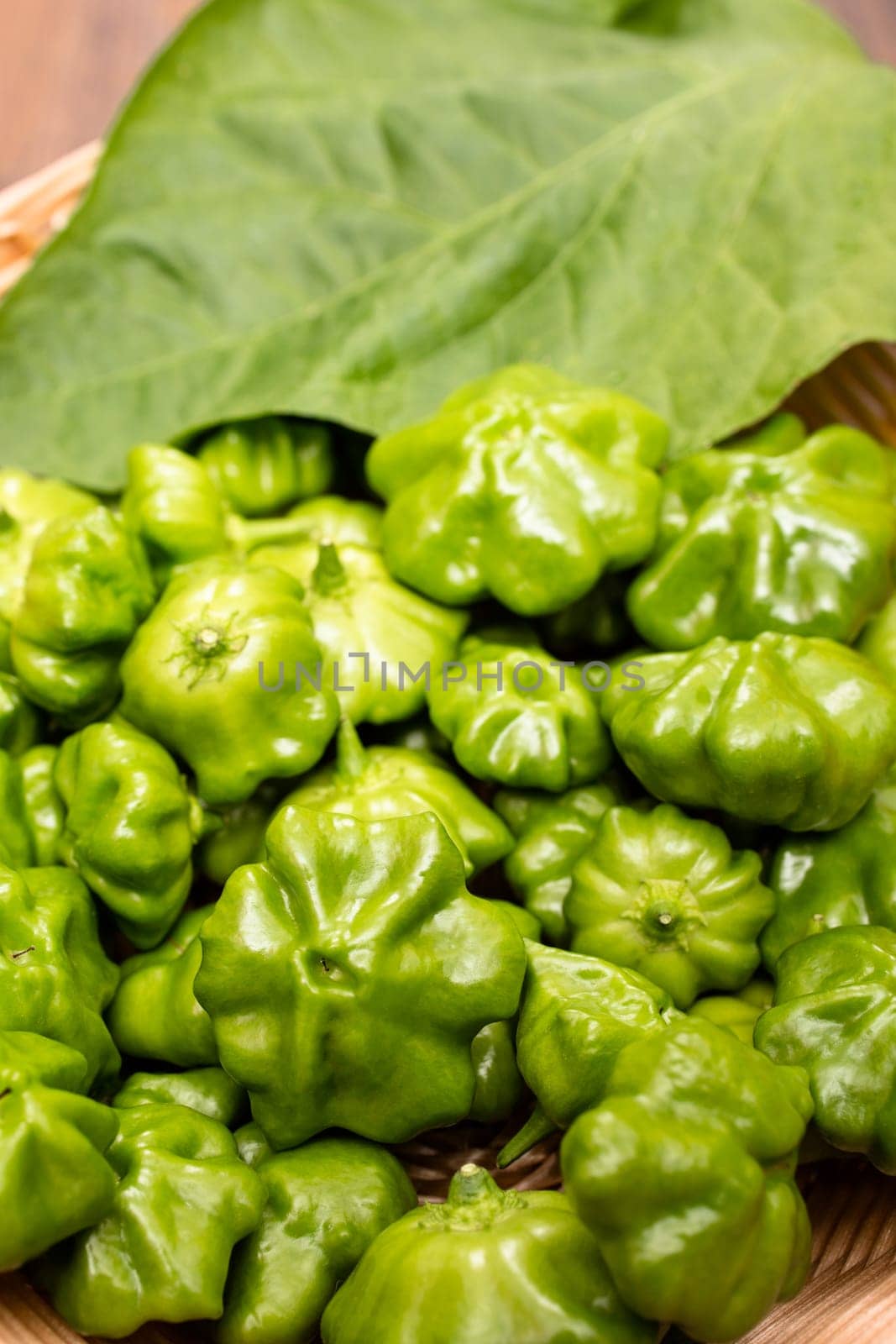 Green chili peppers with leaf in portrait format