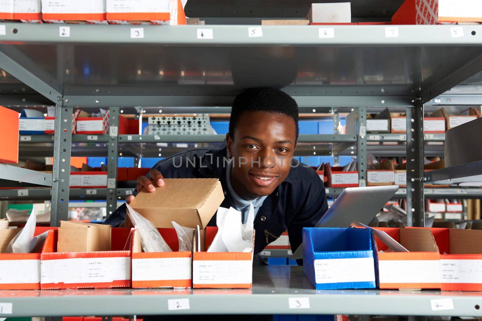 Factory Worker Using Digital Tablet In Warehouse