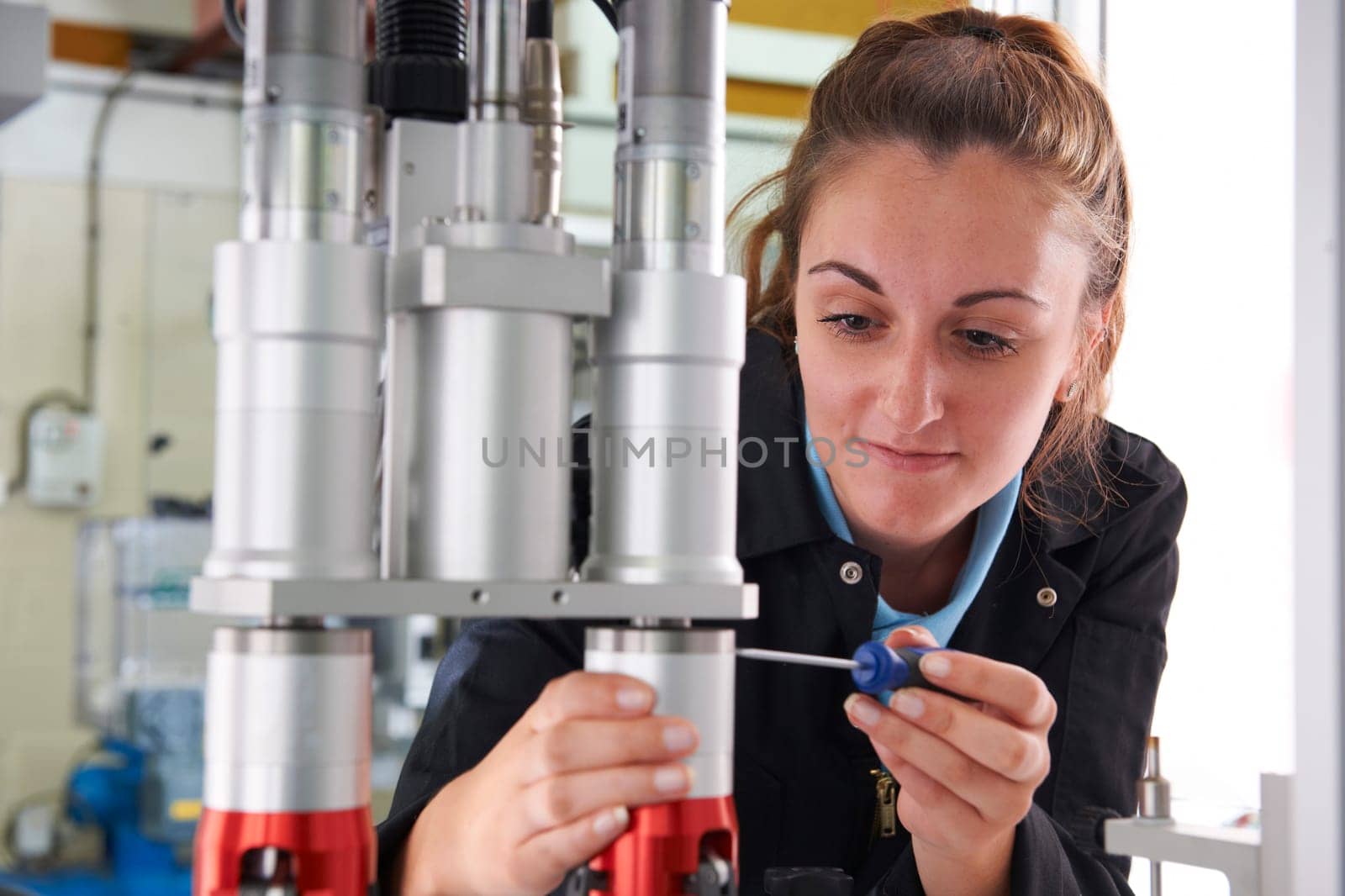 Engineer Working On Machine In Factory