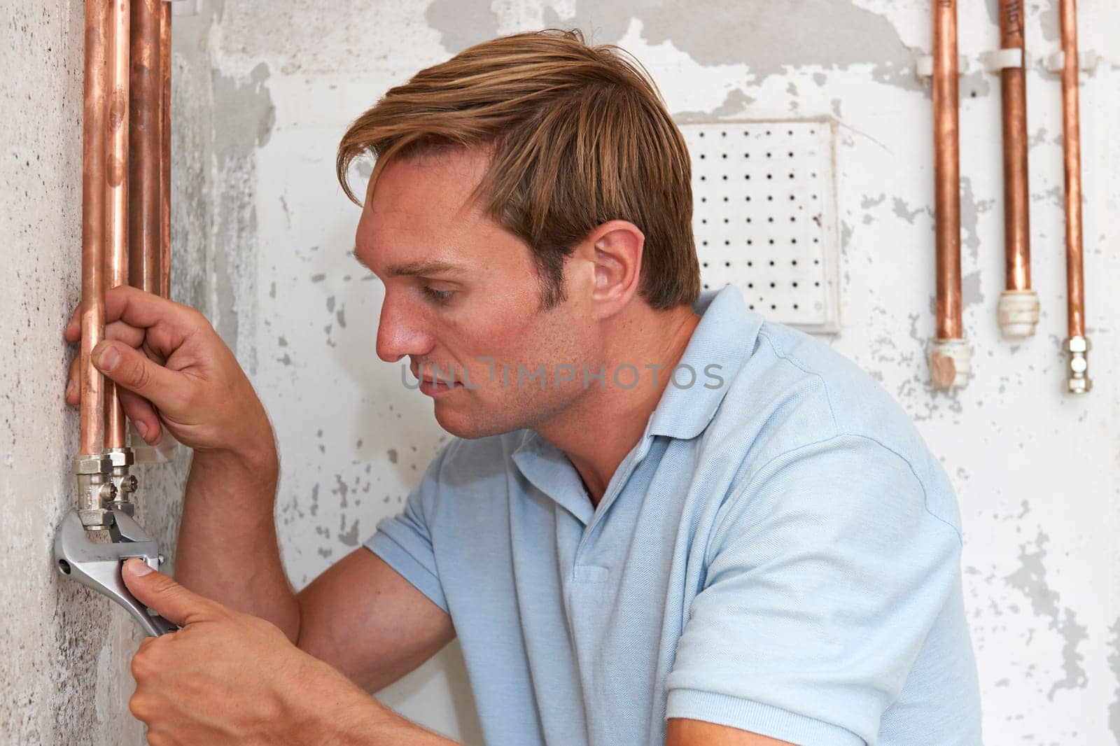 Plumber Fitting Pipes On Construction Site