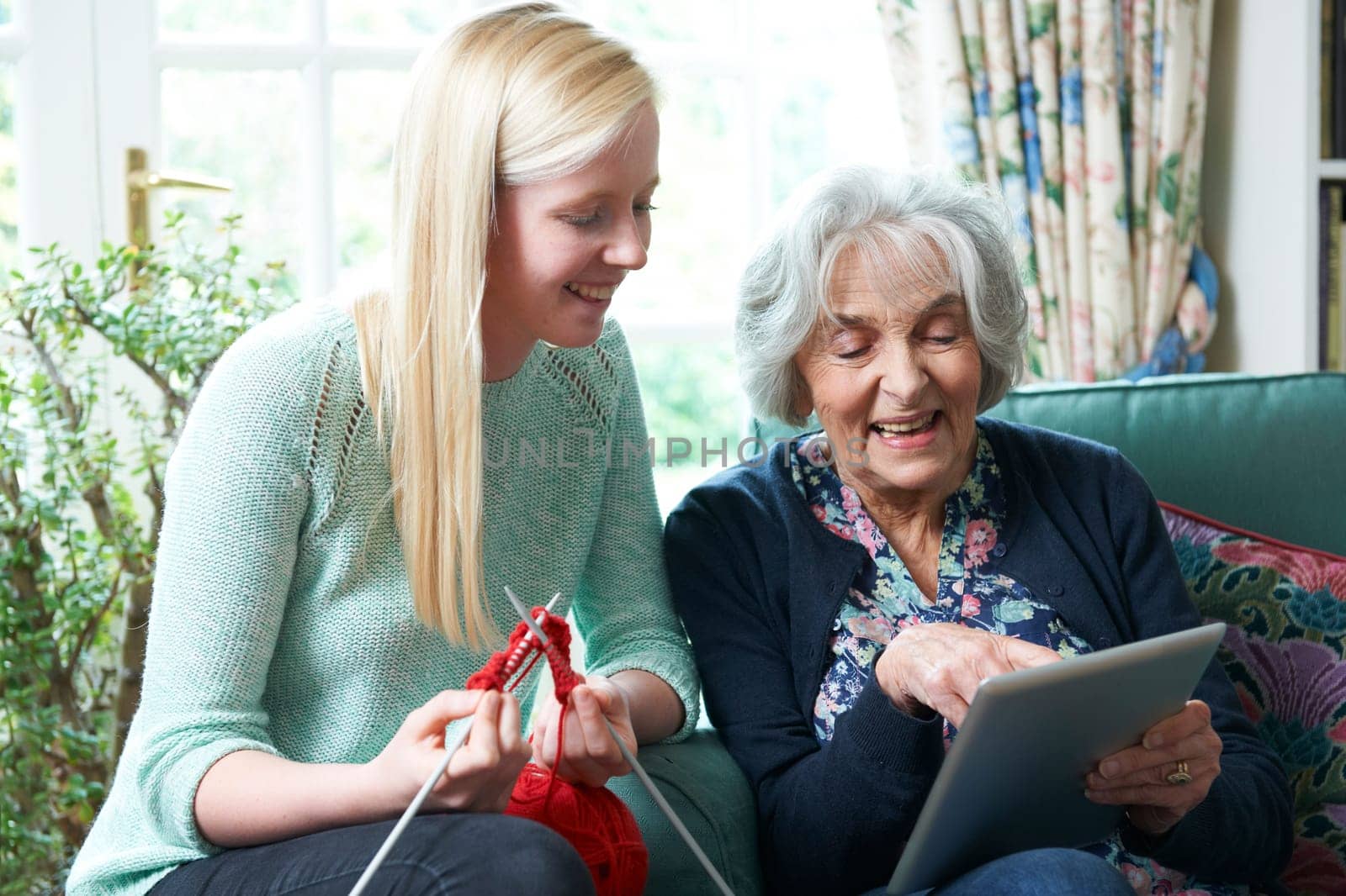 Grandmother Using Digital Tablet Asd Granddaughter Knits
