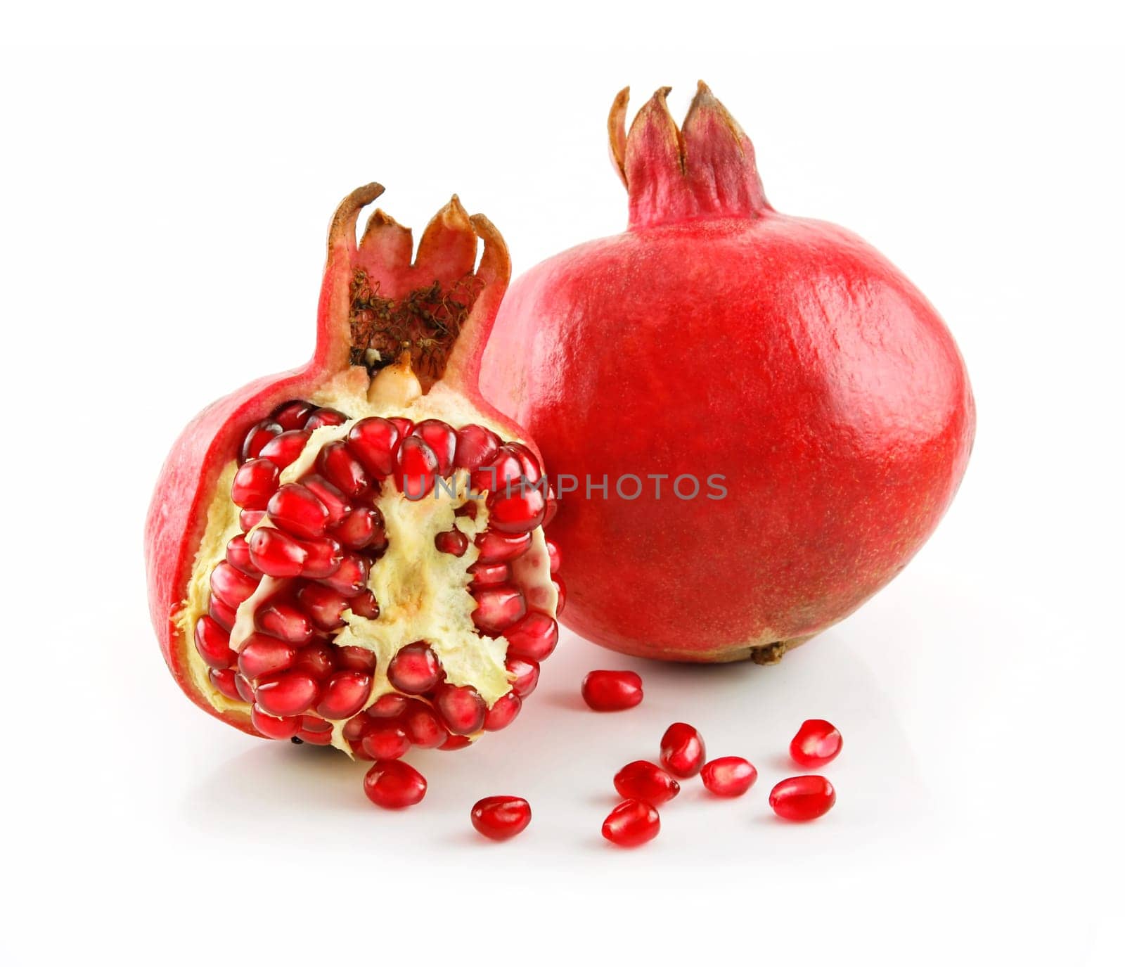Ripe Sliced Pomegranate Fruit with Seeds Isolated on White Background