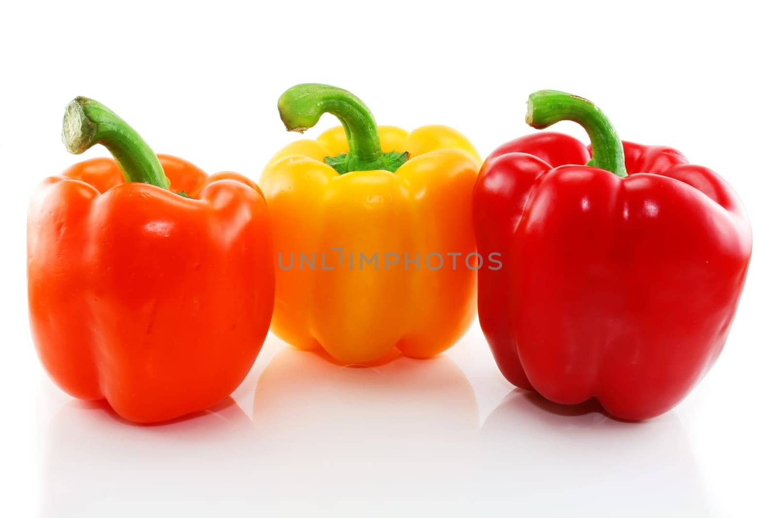 Three colored paprika isolated on a white background