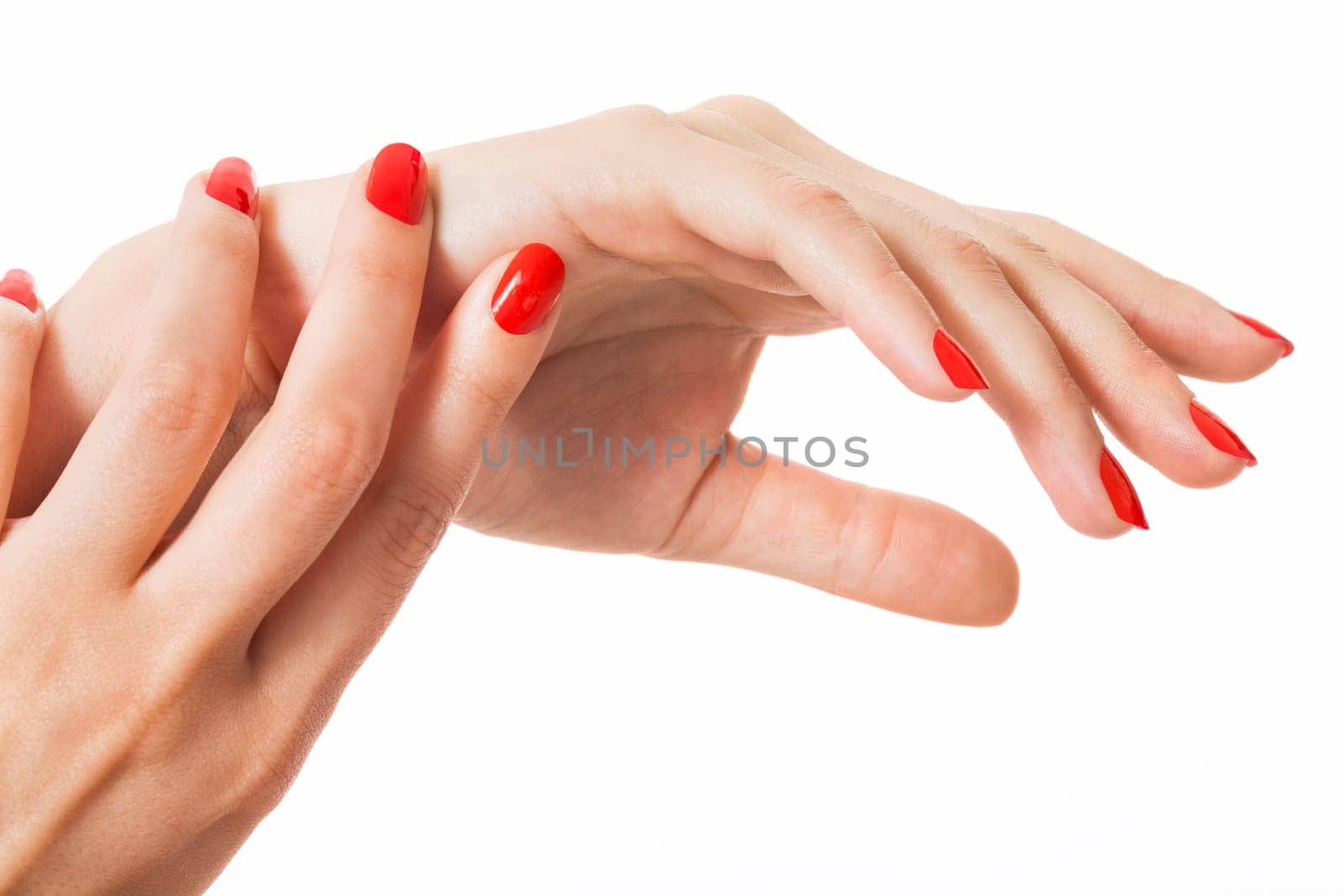 Women's hands with beautiful well-groomed fingers and red nail polish wellness beauty spa close up isolated on white background