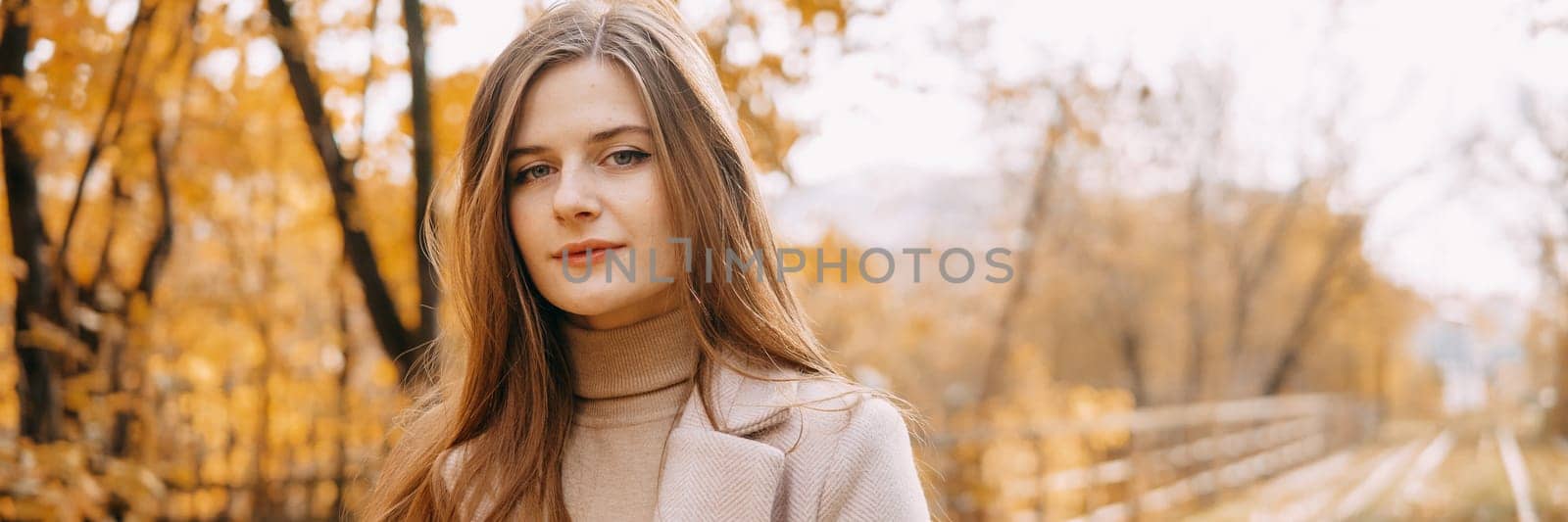 beautiful long-haired woman walks through the autumn streets. Railway, autumn, woman in a coat by Annu1tochka