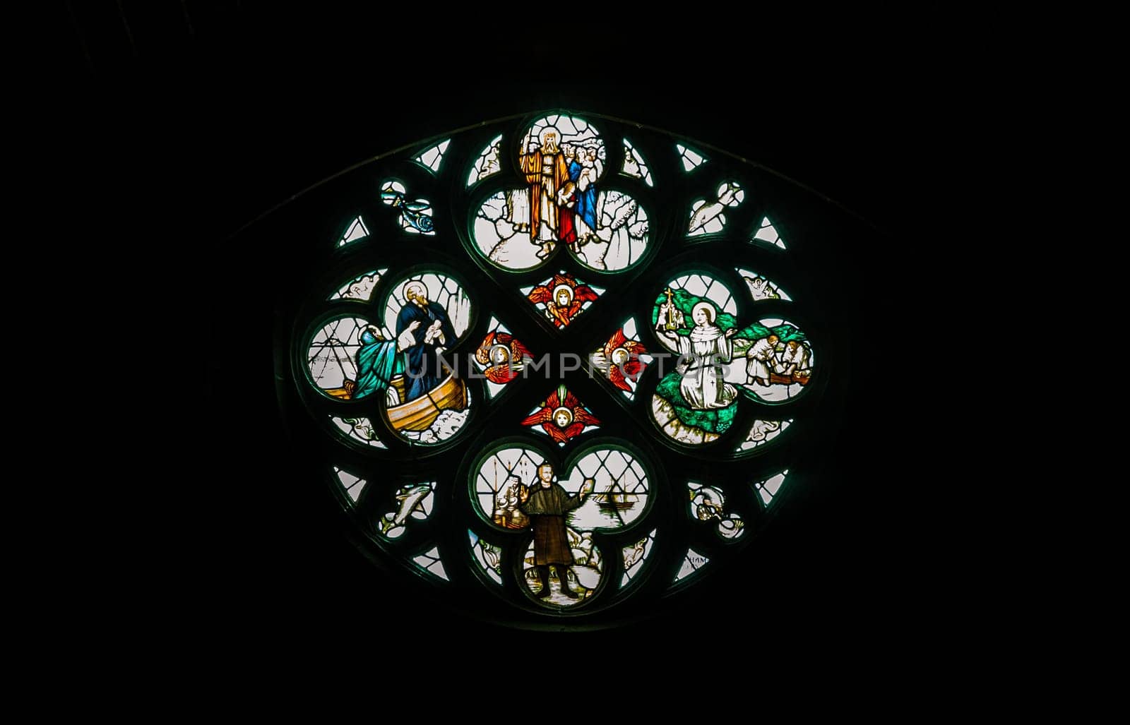 Liverpool, England - Oct 07, 2023 - Silhouette of Stained glass window, Pattern of Medieval gothic rose window in Liverpool cathedral, Inside view, Space for text, Selective focus.