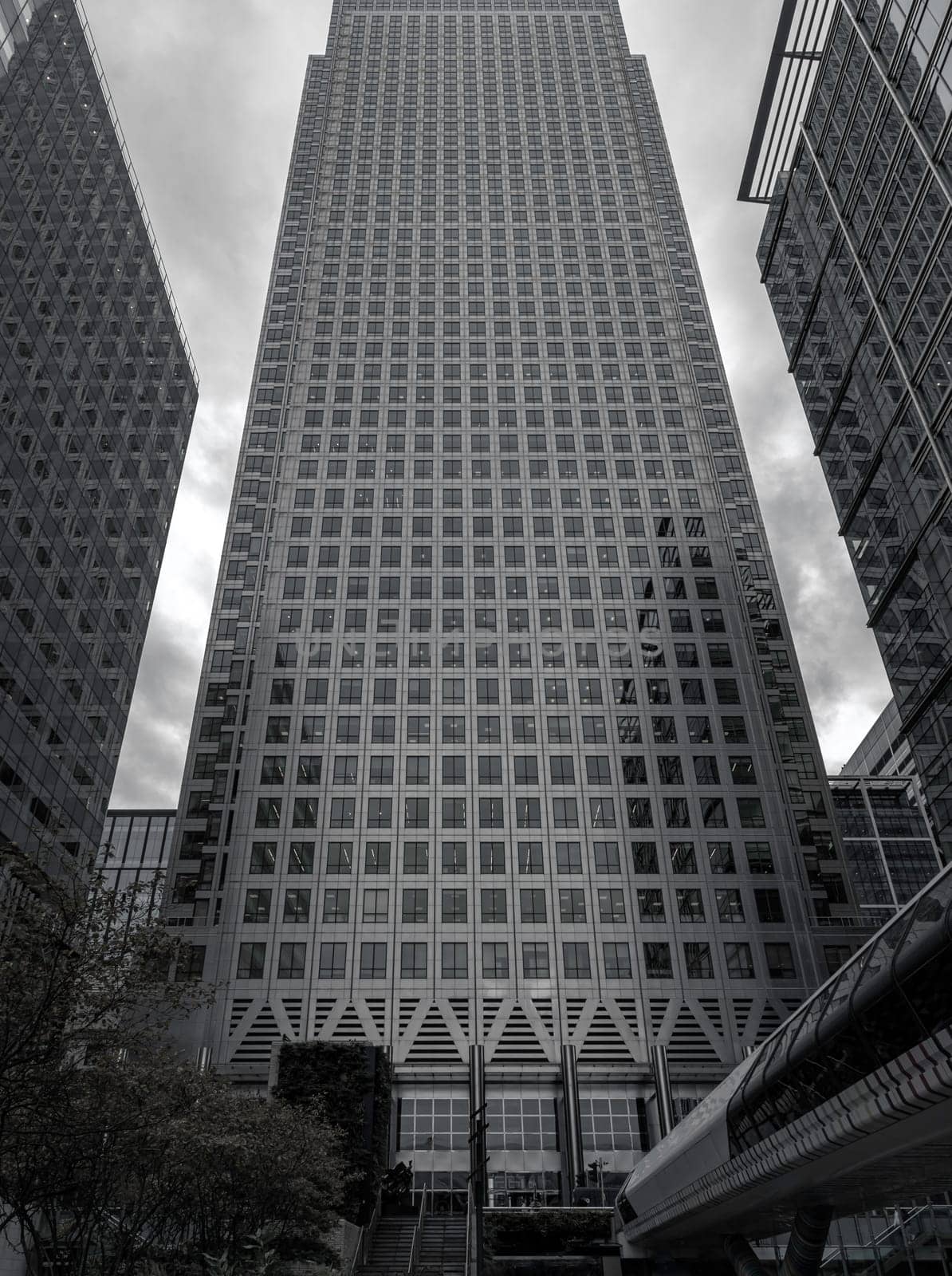 London, UK - Oct 16, 2023 - Upward view of Skyscrapers in the business district area of One Canada Square in Canary Wharf. Tall structure architecture in the capital city. Architectural exterior view, Copy space, Selective focus.