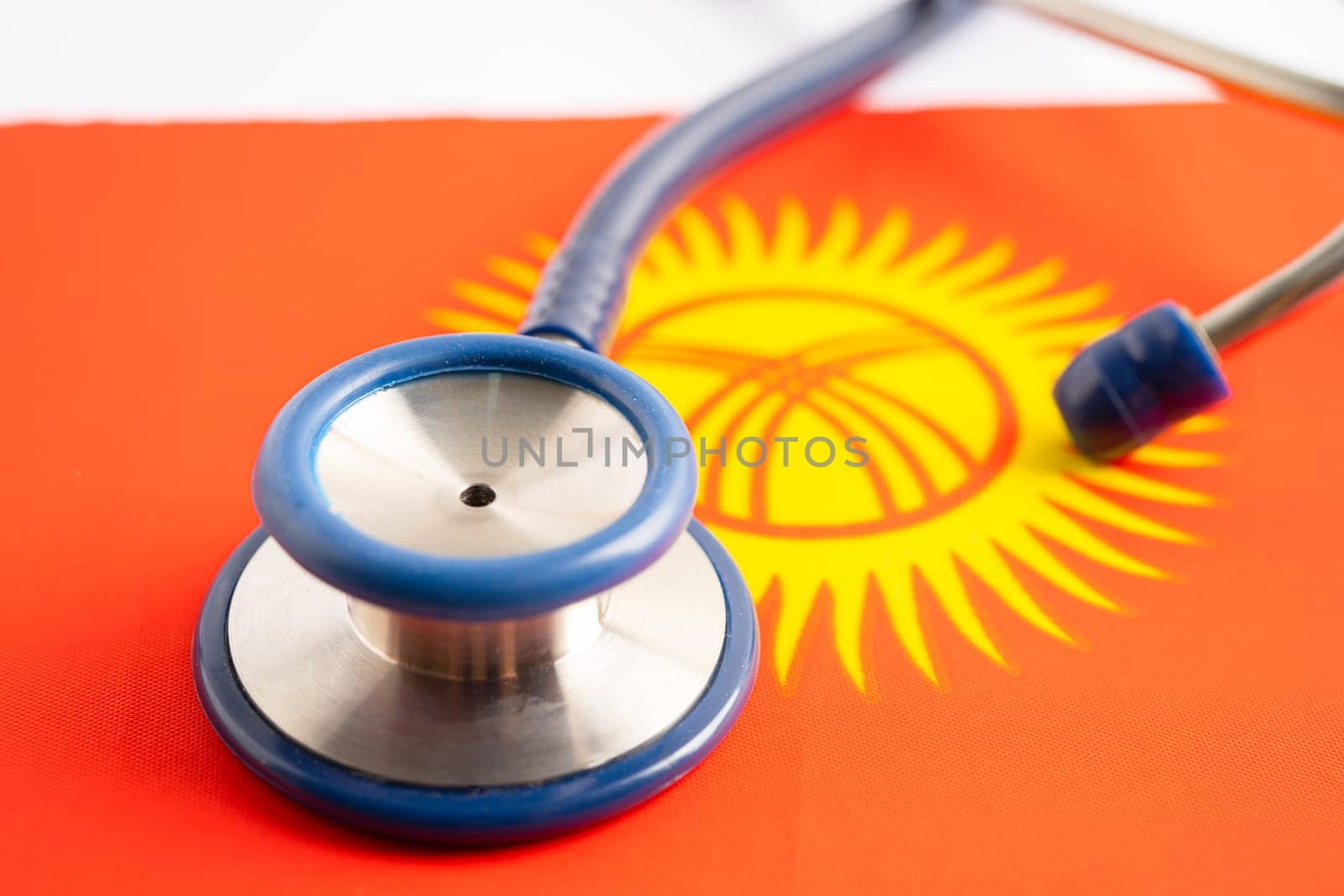 Stethoscope on Kyrgyzstan flag background, Business and finance concept. by pamai