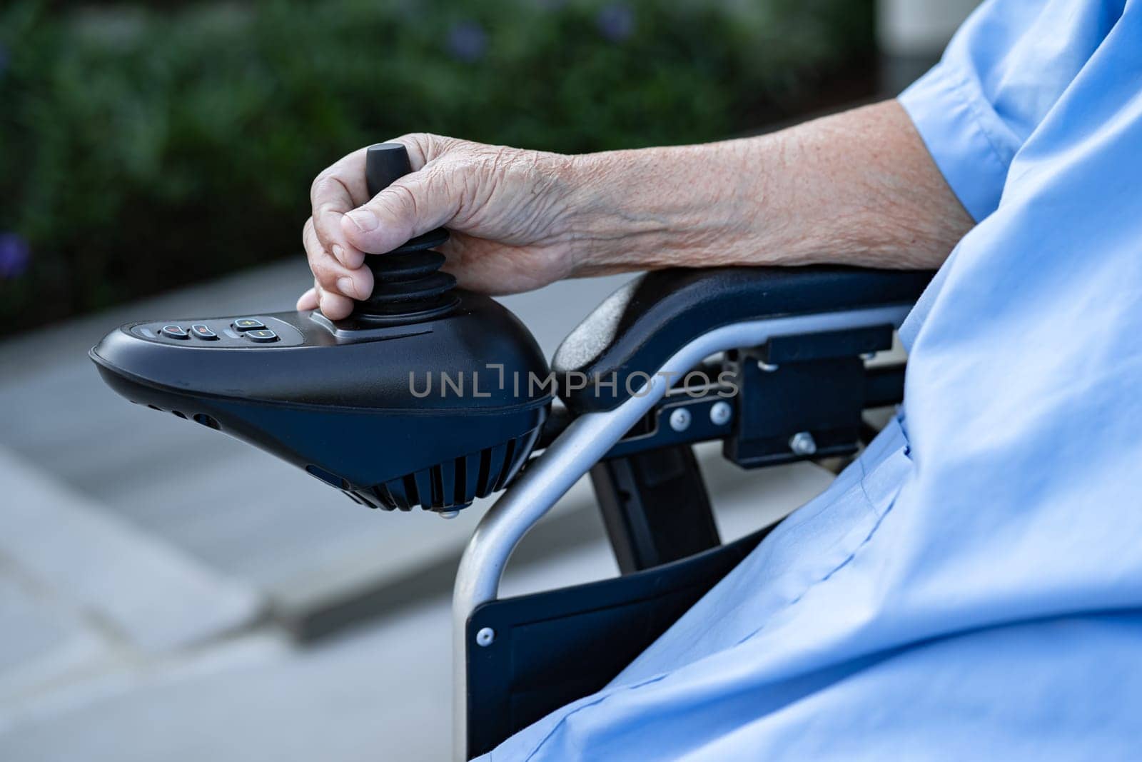 Asian senior woman patient on electric wheelchair with remote control at hospital, healthy strong medical concept.