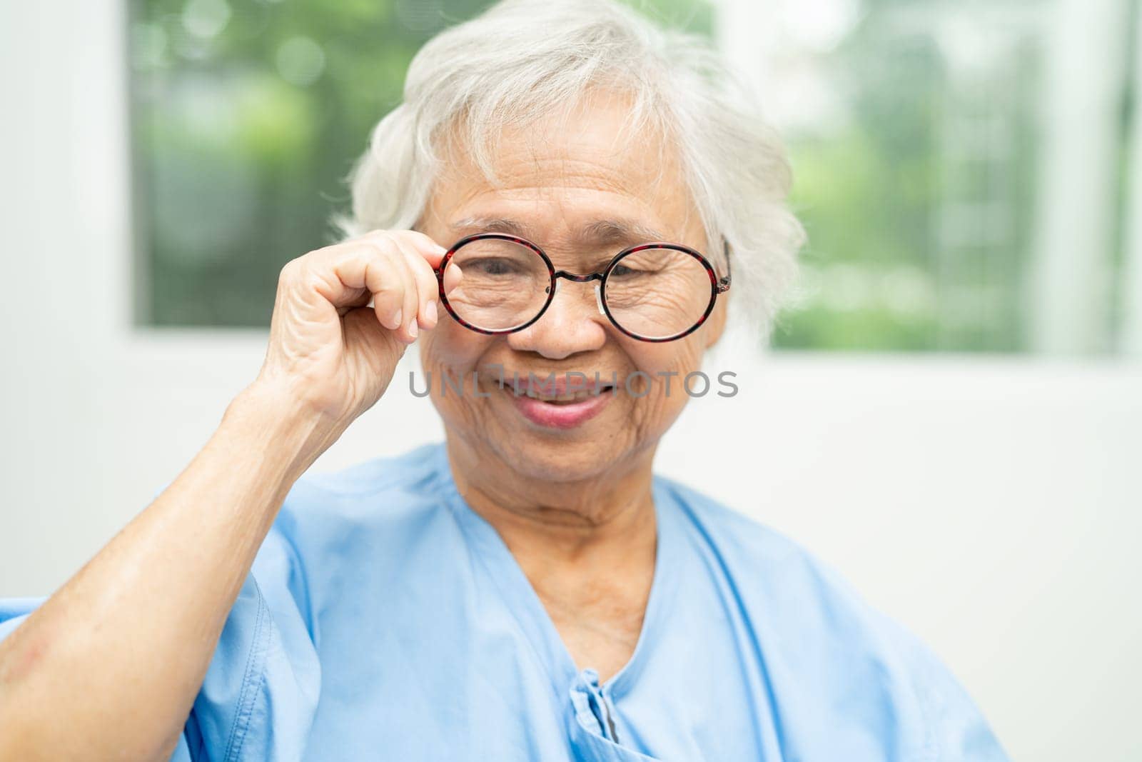 Asian senior woman wearing eyeglasses or vision glasses at home care service.