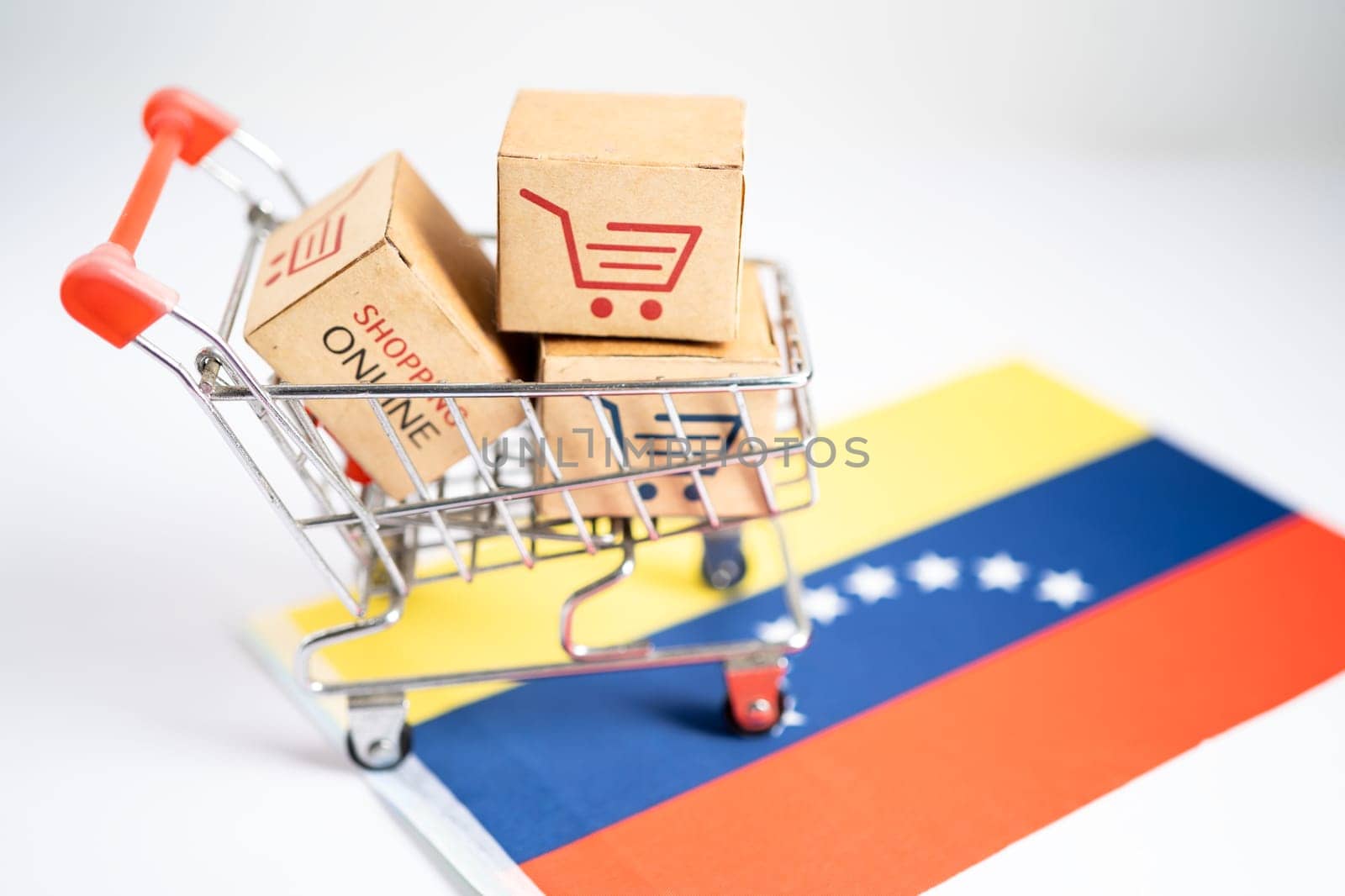 Box with shopping online cart logo and North Venezuela flag, Import Export commerce finance delivery trade.