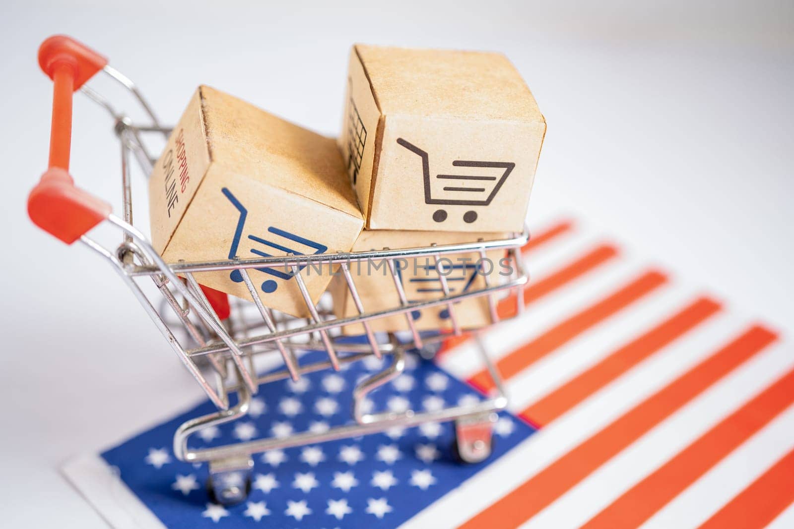 Box with shopping online cart logo and USA America flag, Import Export Shopping online or commerce finance delivery service store product trade, supplier. by pamai