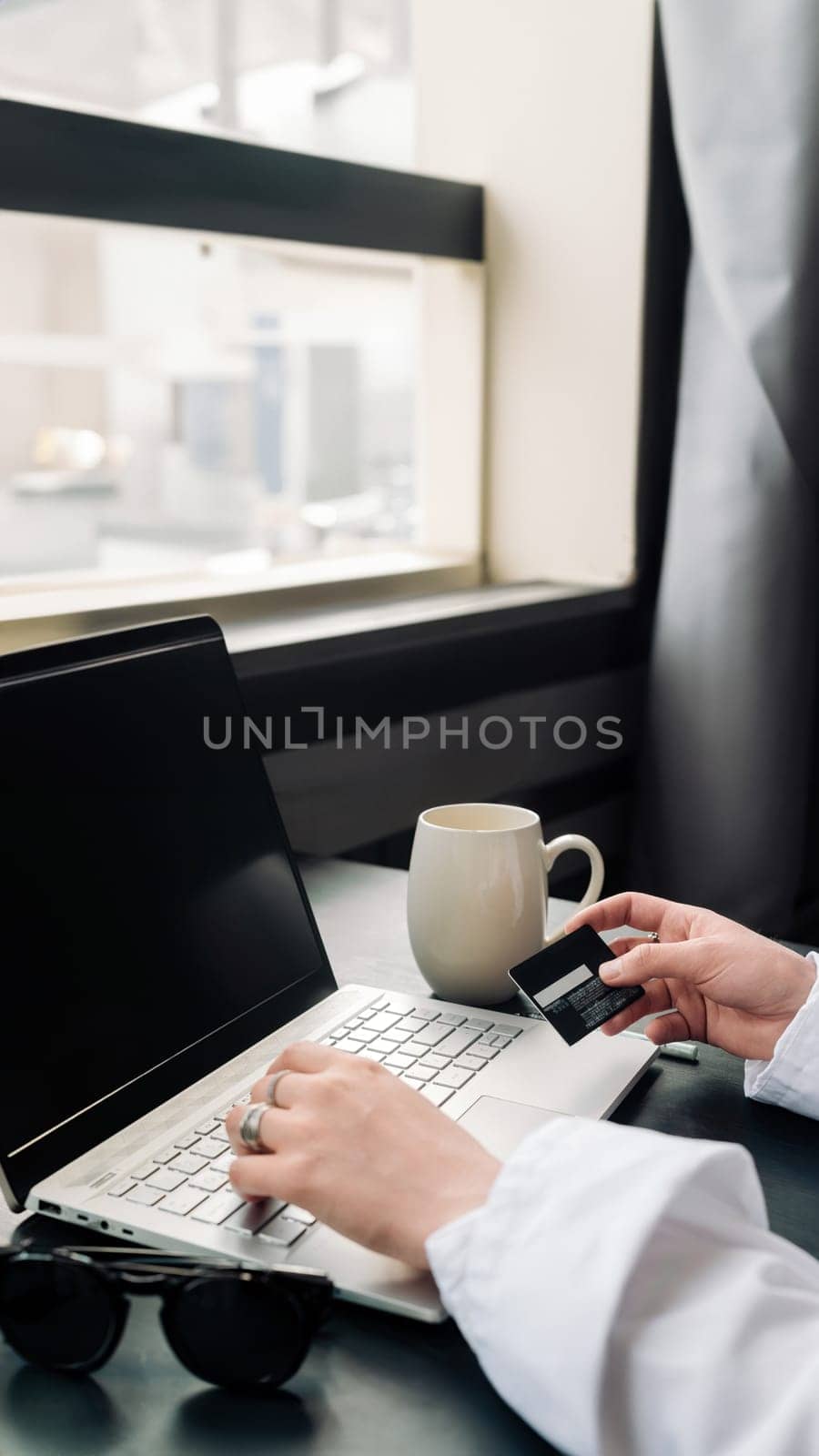 Elegant Woman's Hands Shopping Online with Laptop and Credit Card. Effortless Online Shopping. Stylish Woman with Credit Card and Laptop. Woman's Hands, Laptop, and Credit Card.