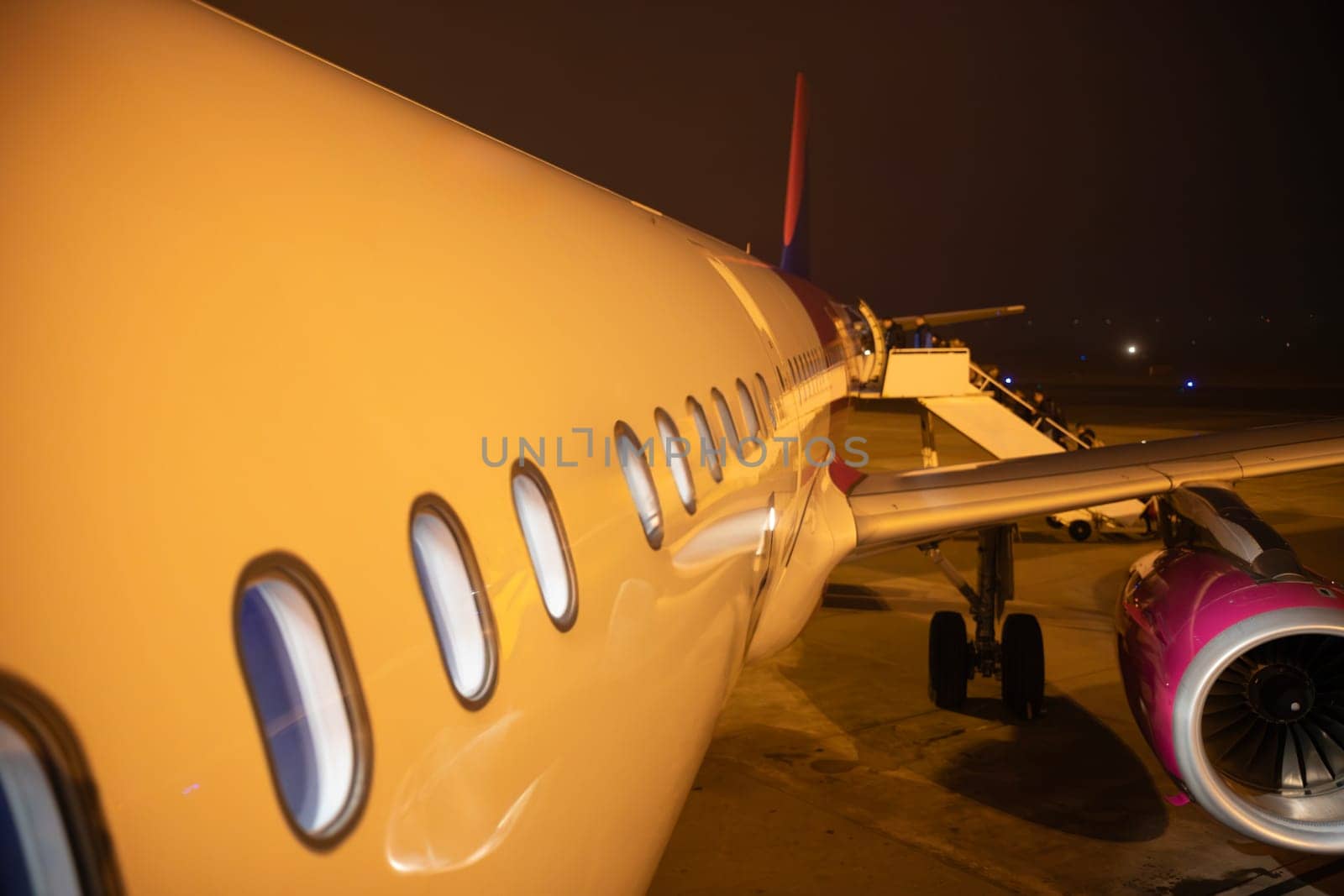 A captivating night view of an airplane, highlighting its design and features.