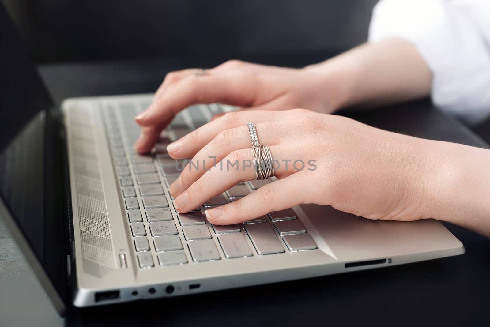 Business Woman's Workspace. Female Hands on Laptop Keyboard. Close-Up. Female Hands Typing on Computer Keyboard for Online Learning.