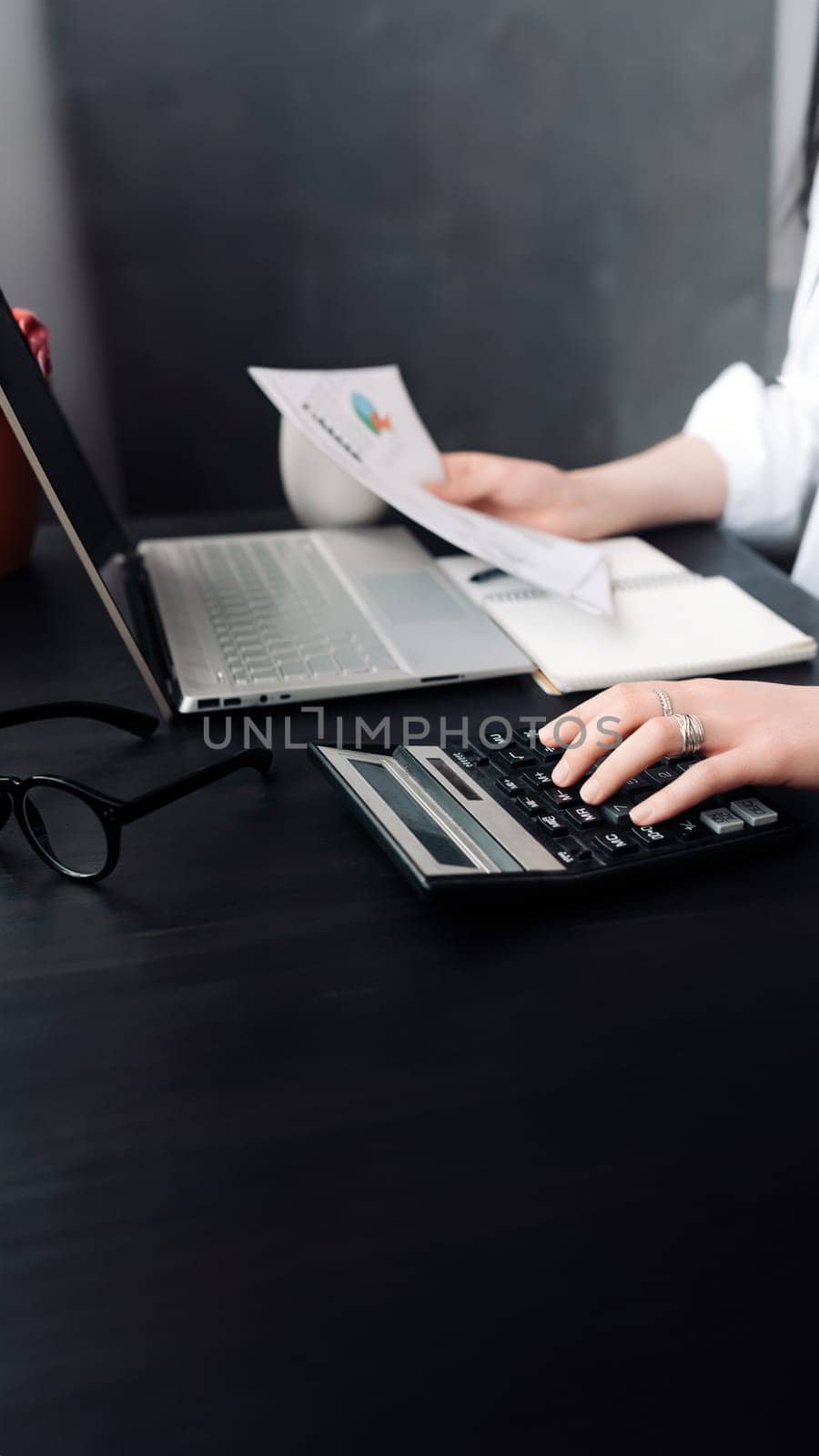 Accountant's Precision. Businesswoman Analyzing Financial Budget, Calculating Finance Report with Calculator, Close-Up Document. Strategic Finance Management: Woman Calculating Budget