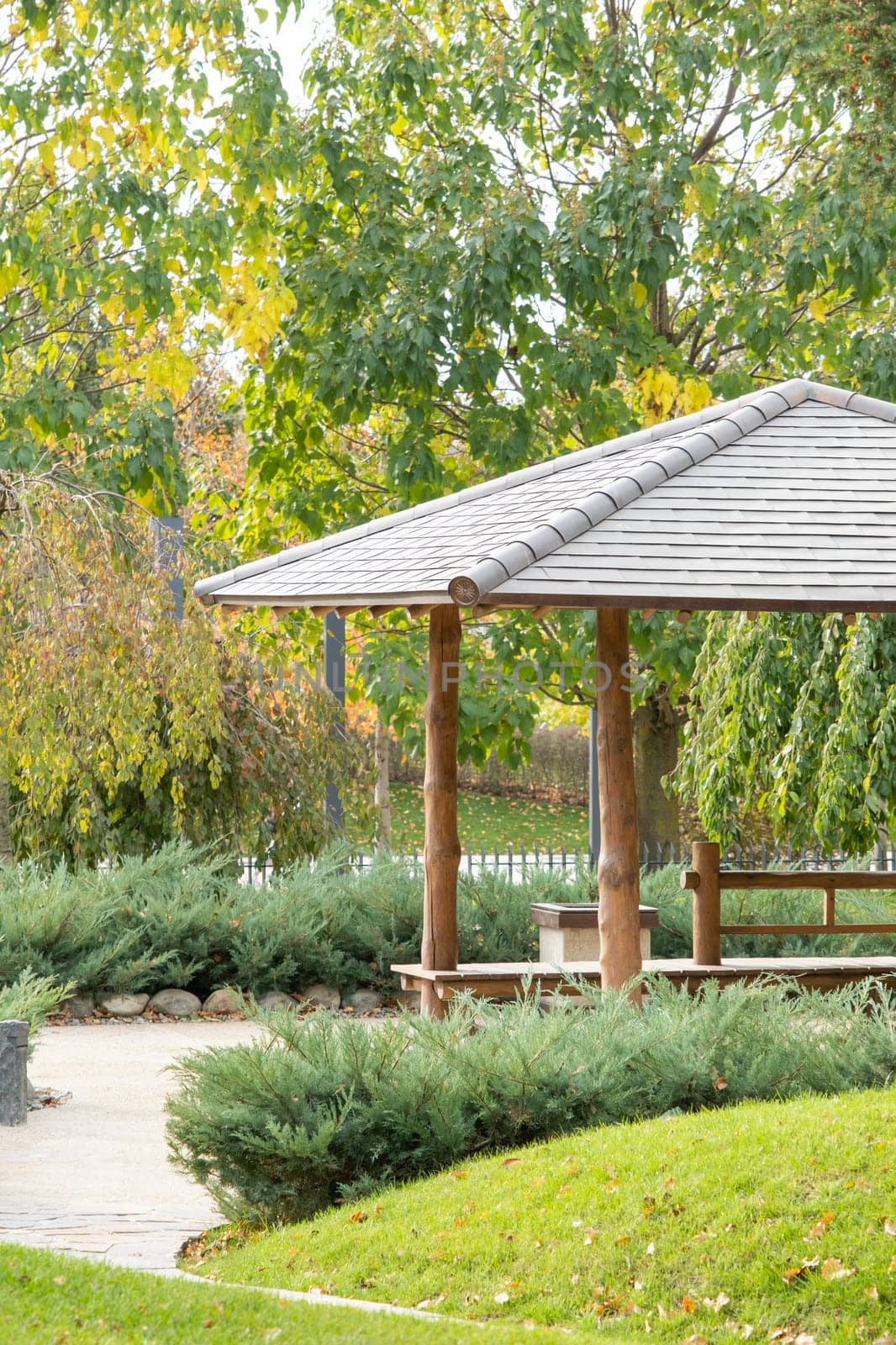 Woman in red plaid shirt enjoying nature sitting in Japanese Garden