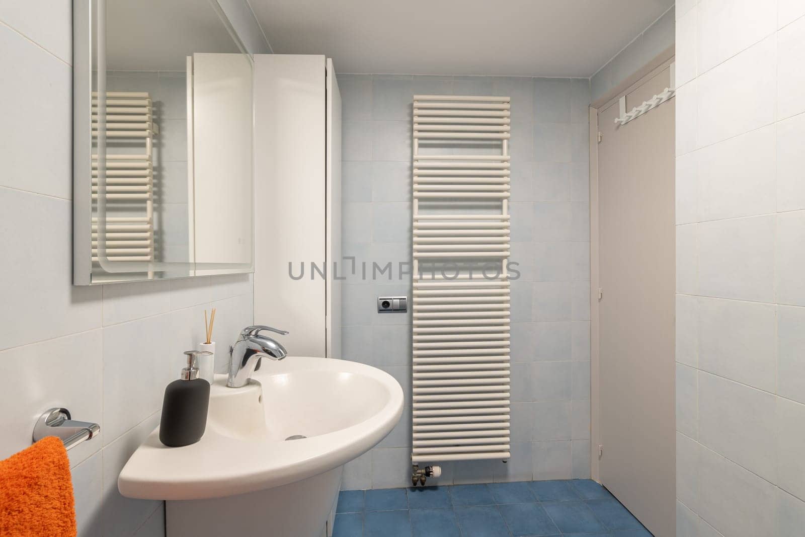 Radiator and cabinet in modern bathroom with vanity area by apavlin