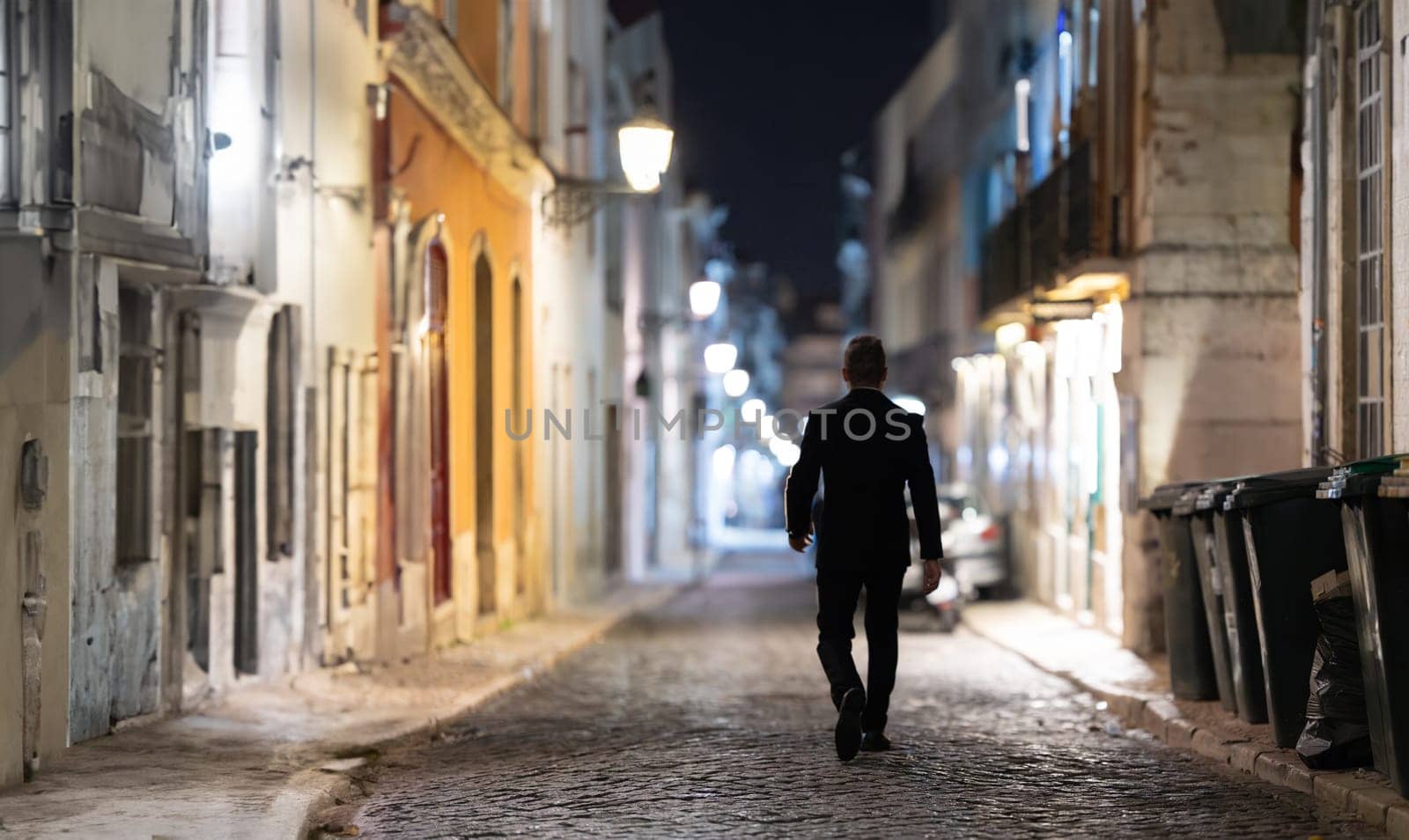 A person walking through the empty night street, lonely man