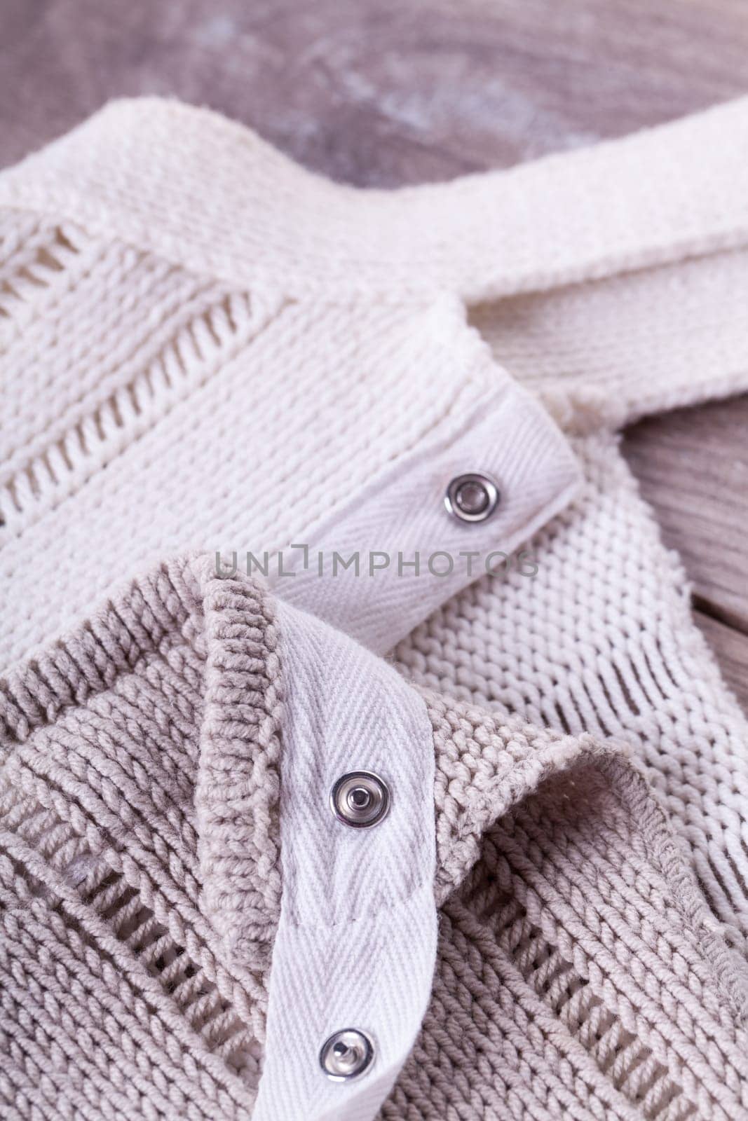 Close-up of a bright fabric tructure knitted from wool background