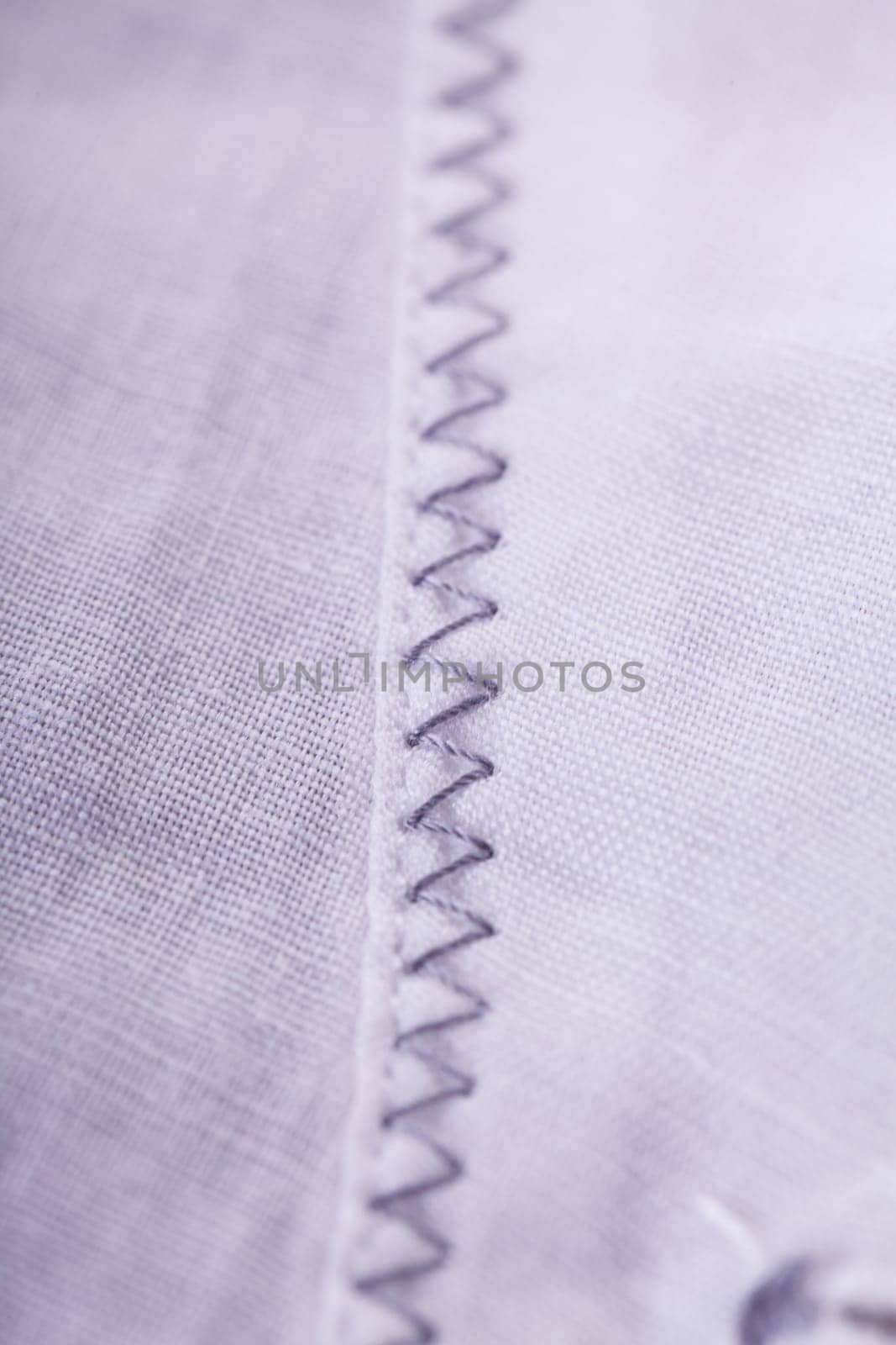 Button strip with button and buttonhole of a blouse as close-up structure texture