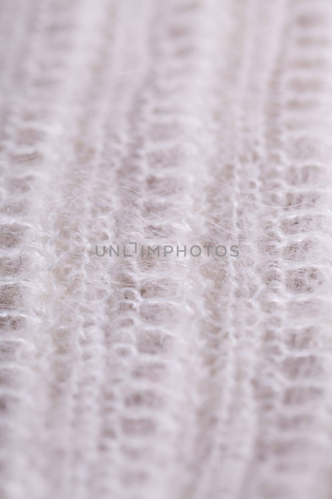 White knitted fabric wool with structure fluffy soft as close-up