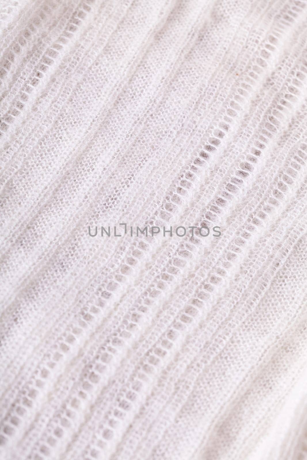 White knitted fabric wool with structure fluffy soft as close-up