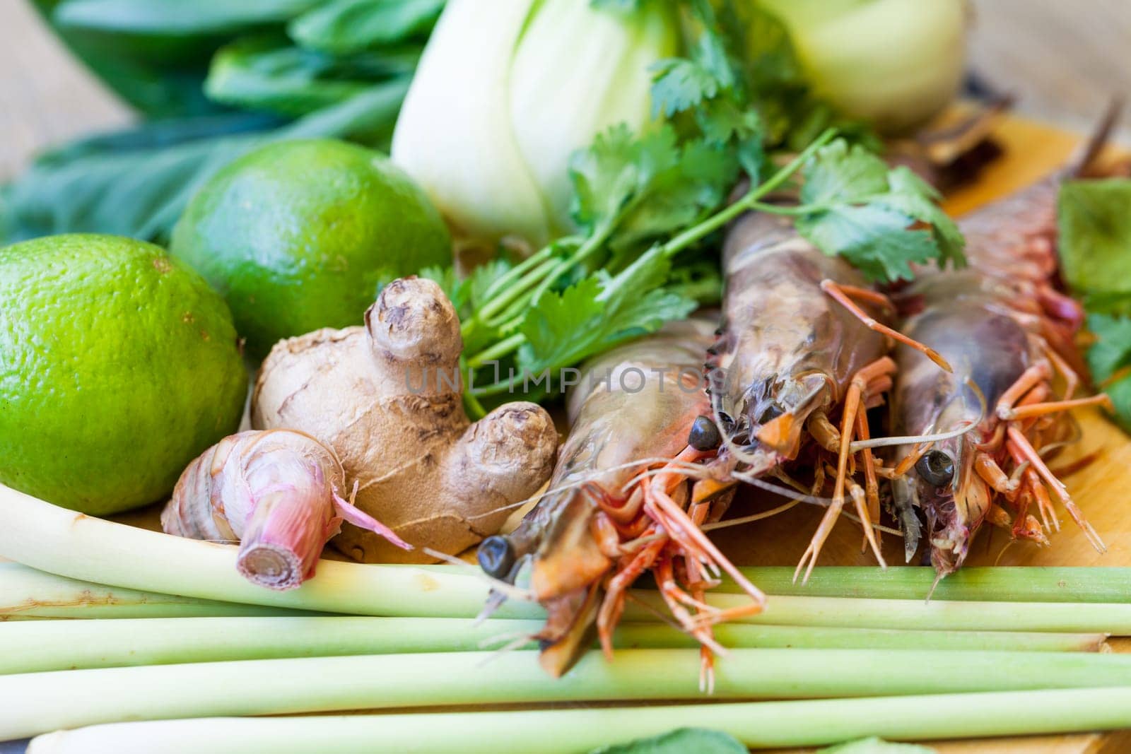 Ingredients for Tom Yam soup with lemongrass shrimp coriander on a kitchen board