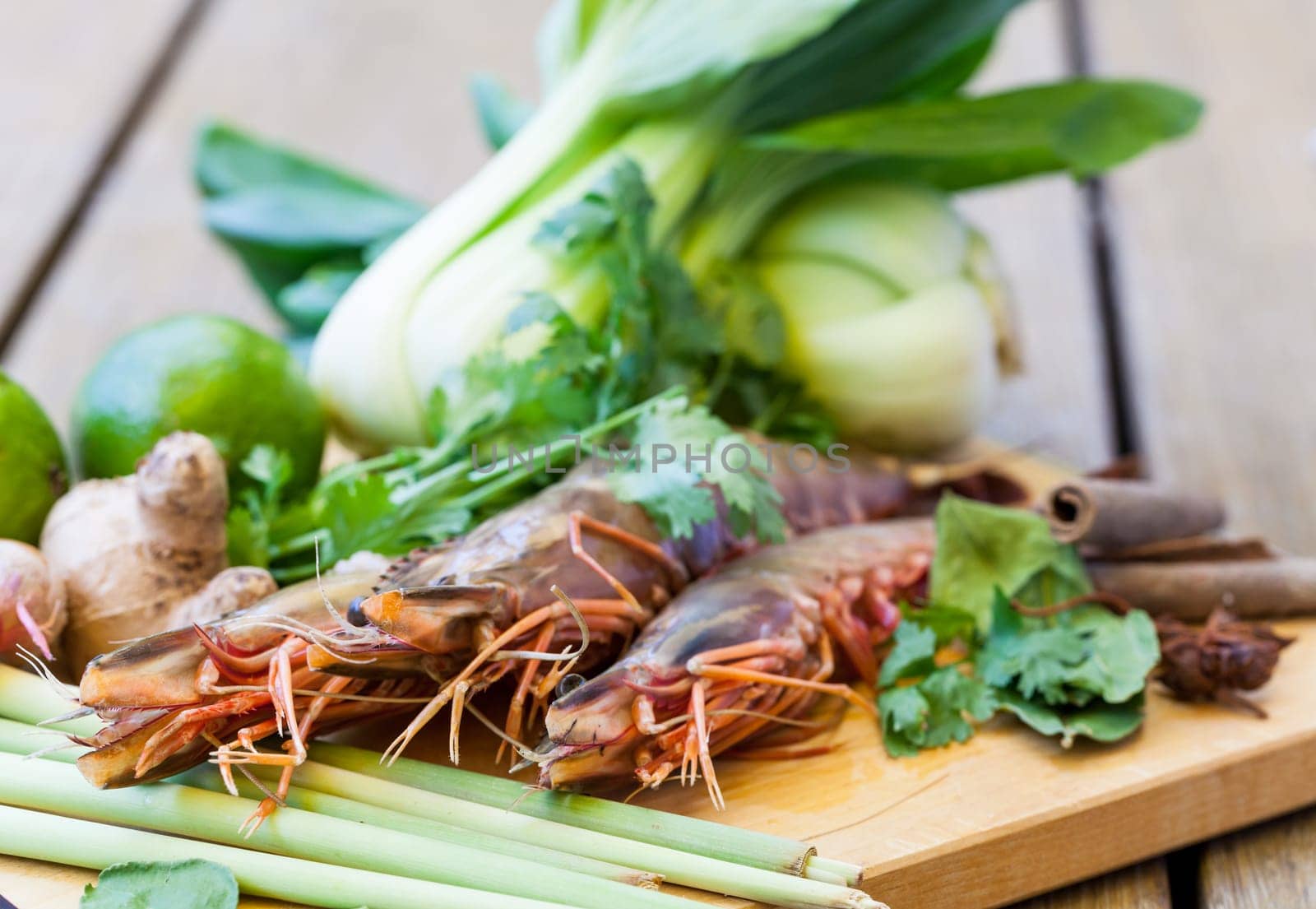 Ingredients for Tom Yam soup with lemongrass shrimp coriander on a kitchen board