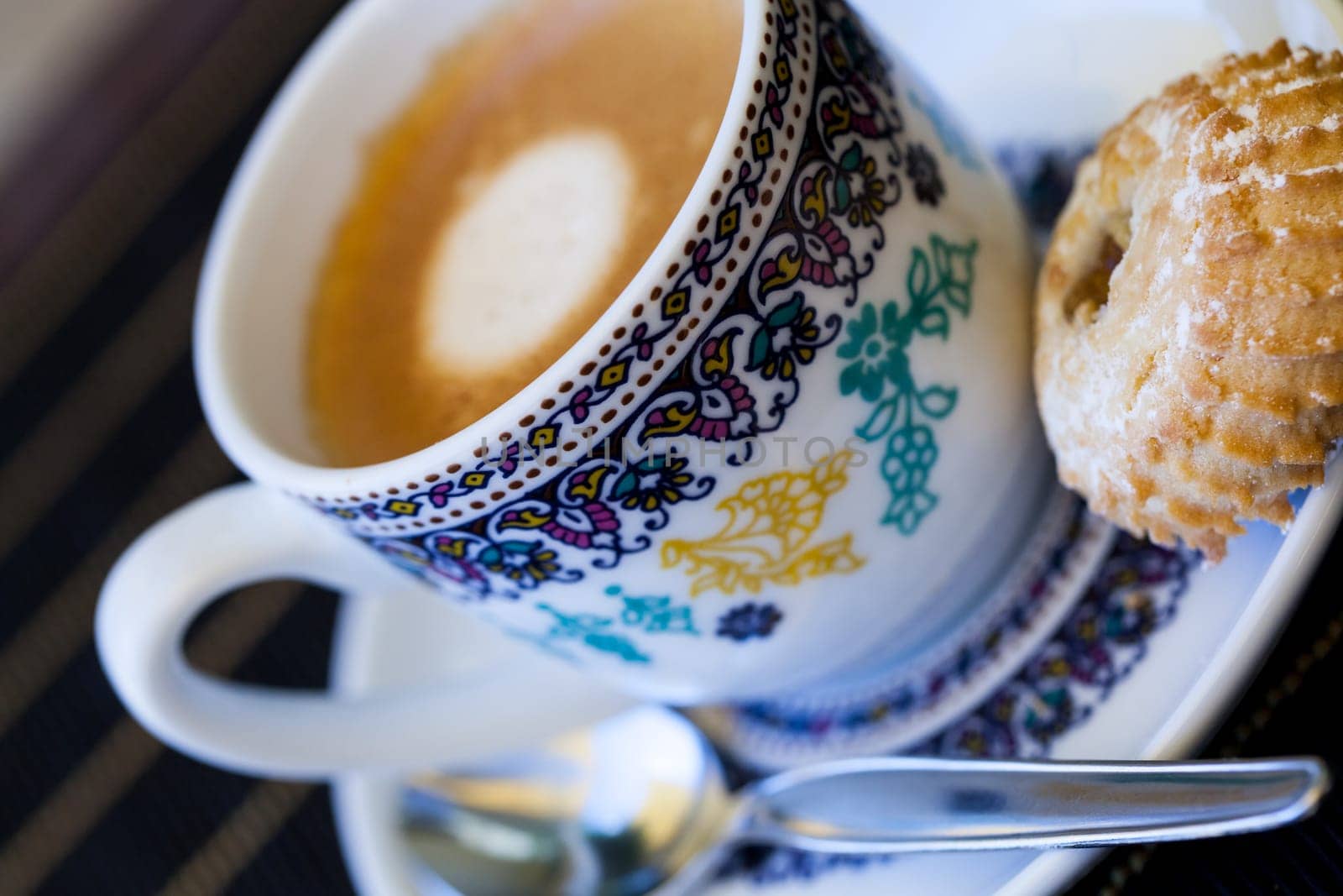 Cup with fresh coffee espresso coffee spoon and pastries as close-up