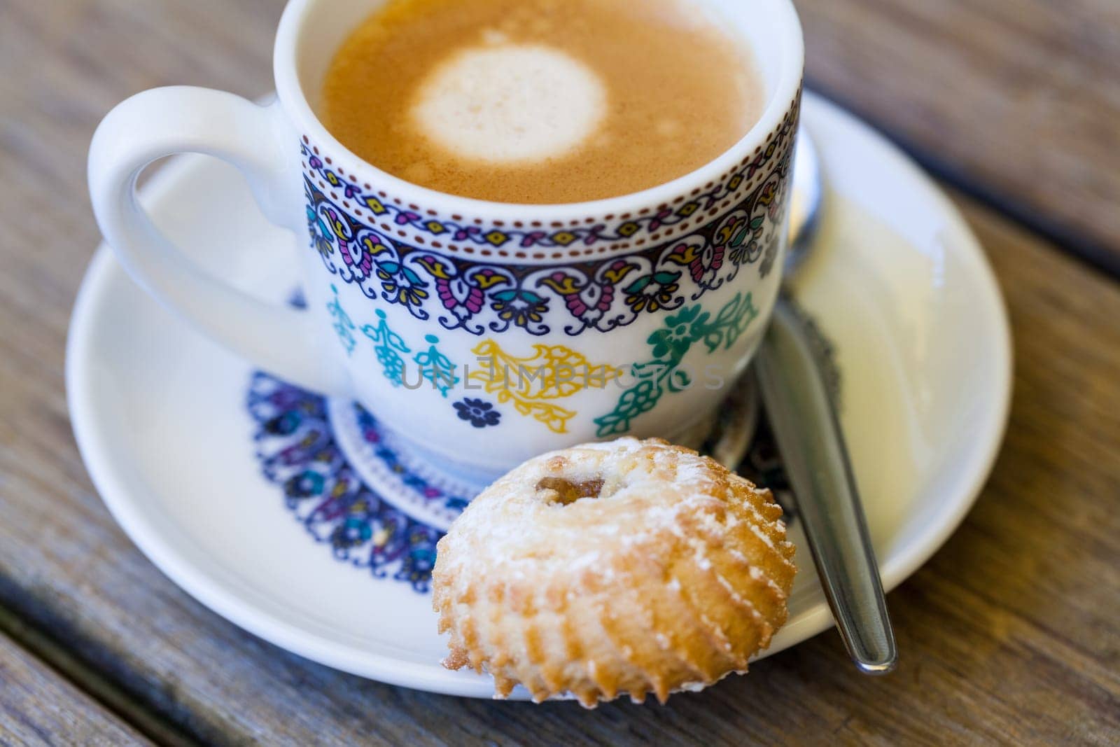 Cup with fresh coffee espresso coffee spoon and pastries as close-up