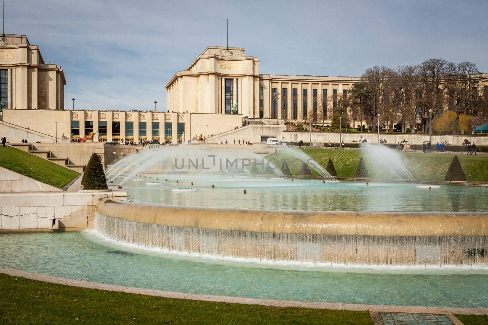 Park in Paris near the Eiffel Tower with a fountain on a sunny day