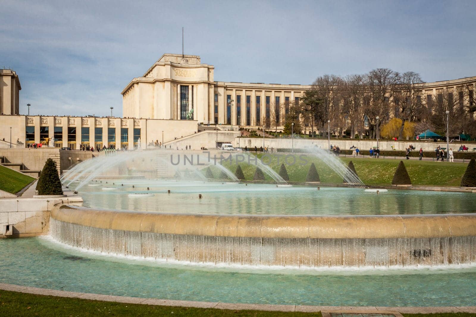 Park in Paris near the Eiffel Tower with a fountain on a sunny day