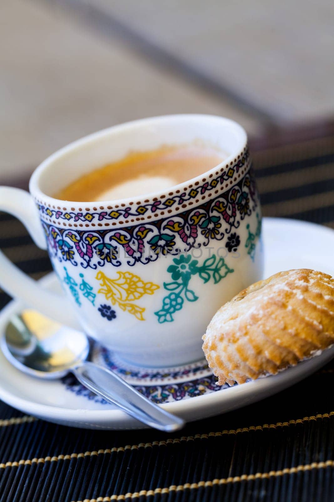 Cup with fresh coffee espresso coffee spoon and pastries as close-up